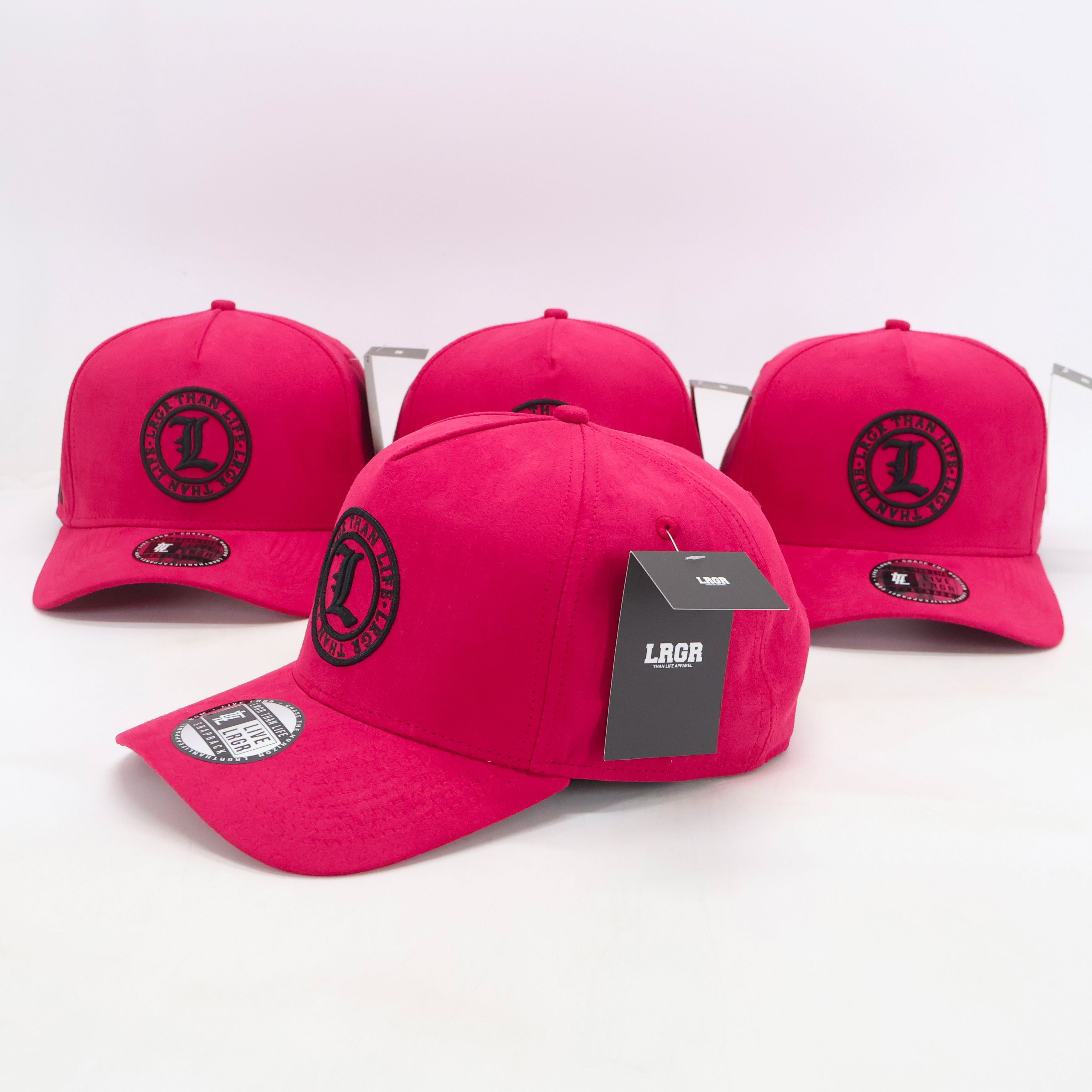 Four pink caps with a brand logo on a white background