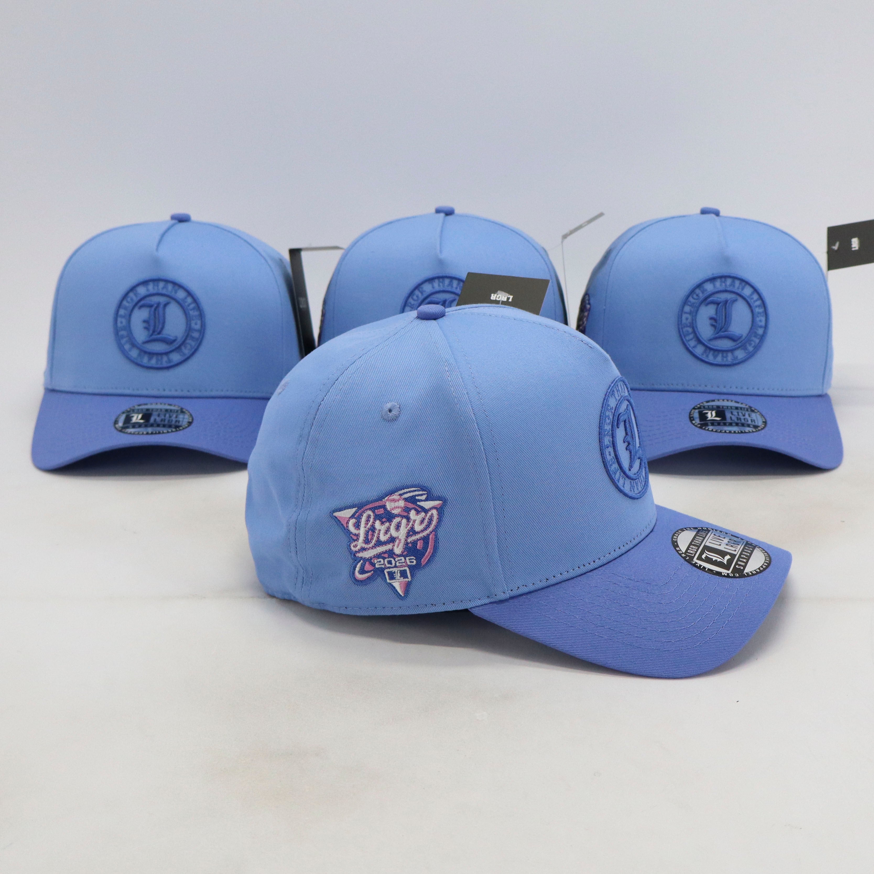Four blue baseball caps with logos on a light gray background