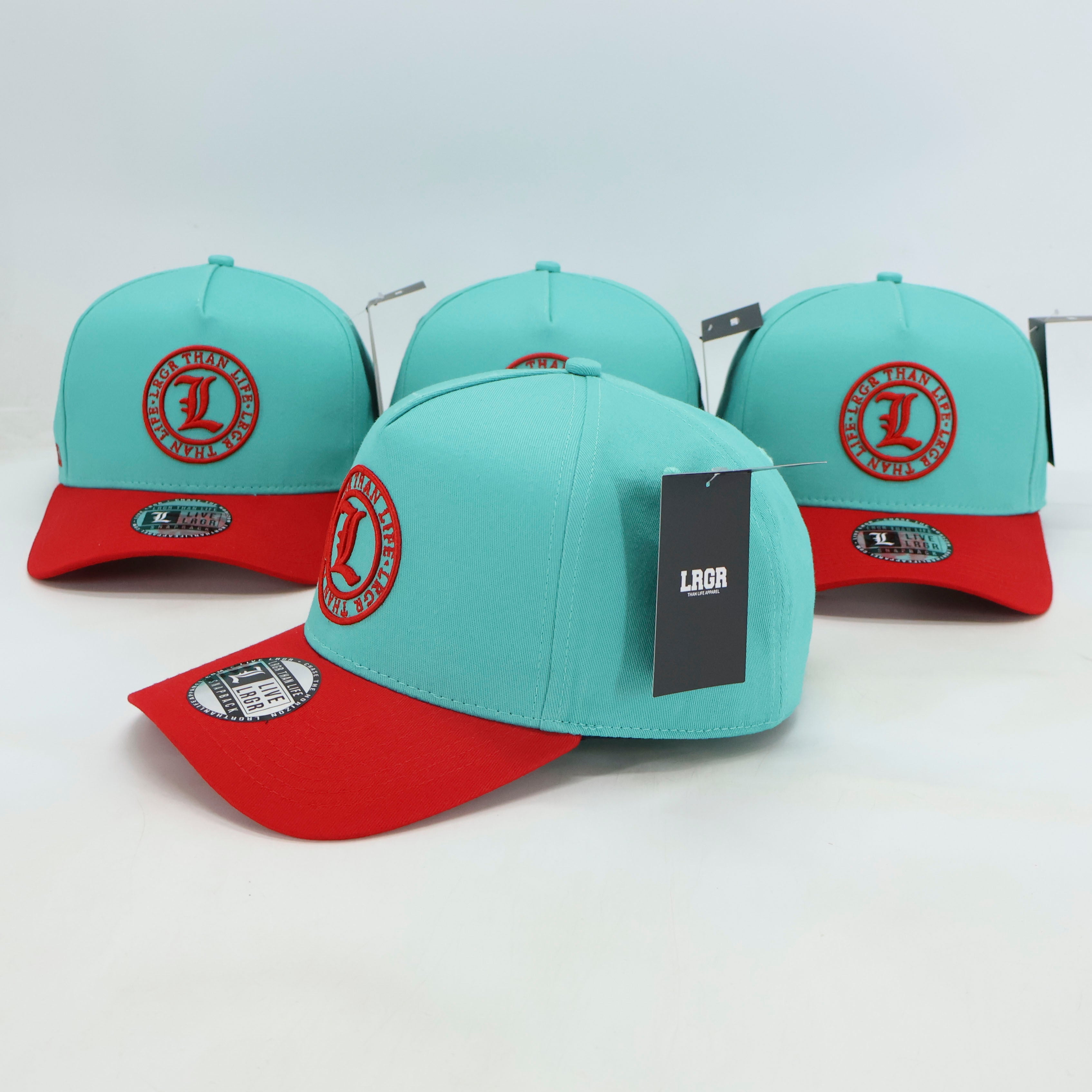 Turquoise and red baseball caps with a visible brand tag on a white background