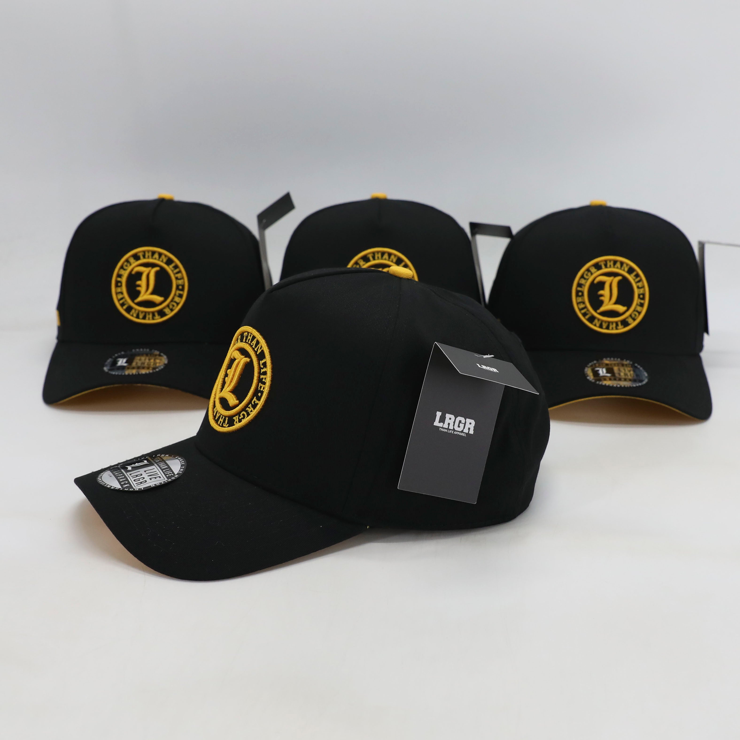 Black caps with yellow logos on a white background