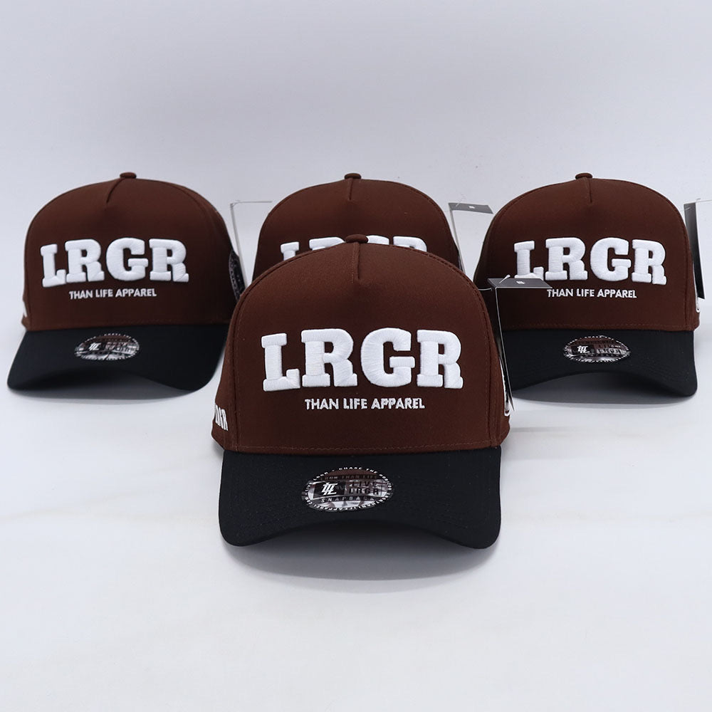 A collection of brown A-frame hats with 'LRGR' and 'THAN LIFE APPAREL' text embroidered on the front.