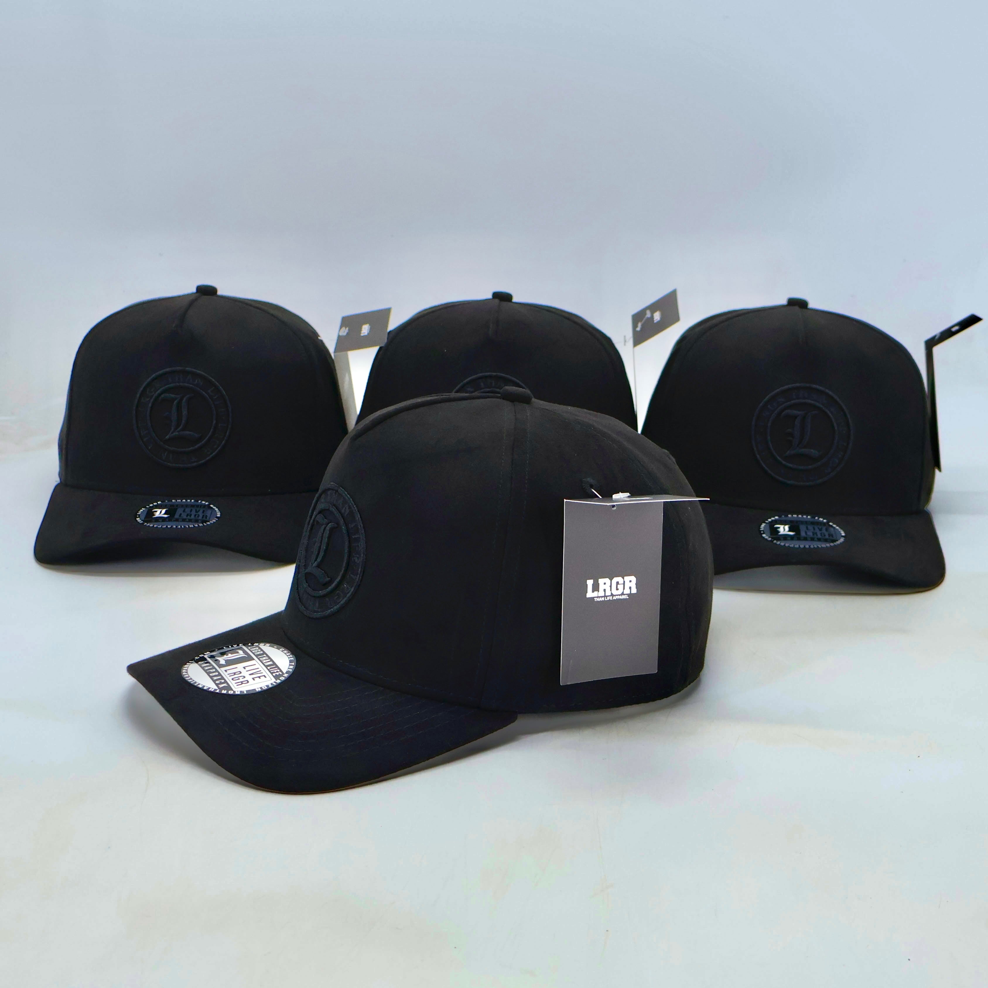 Four black baseball caps with brand logos on a white background