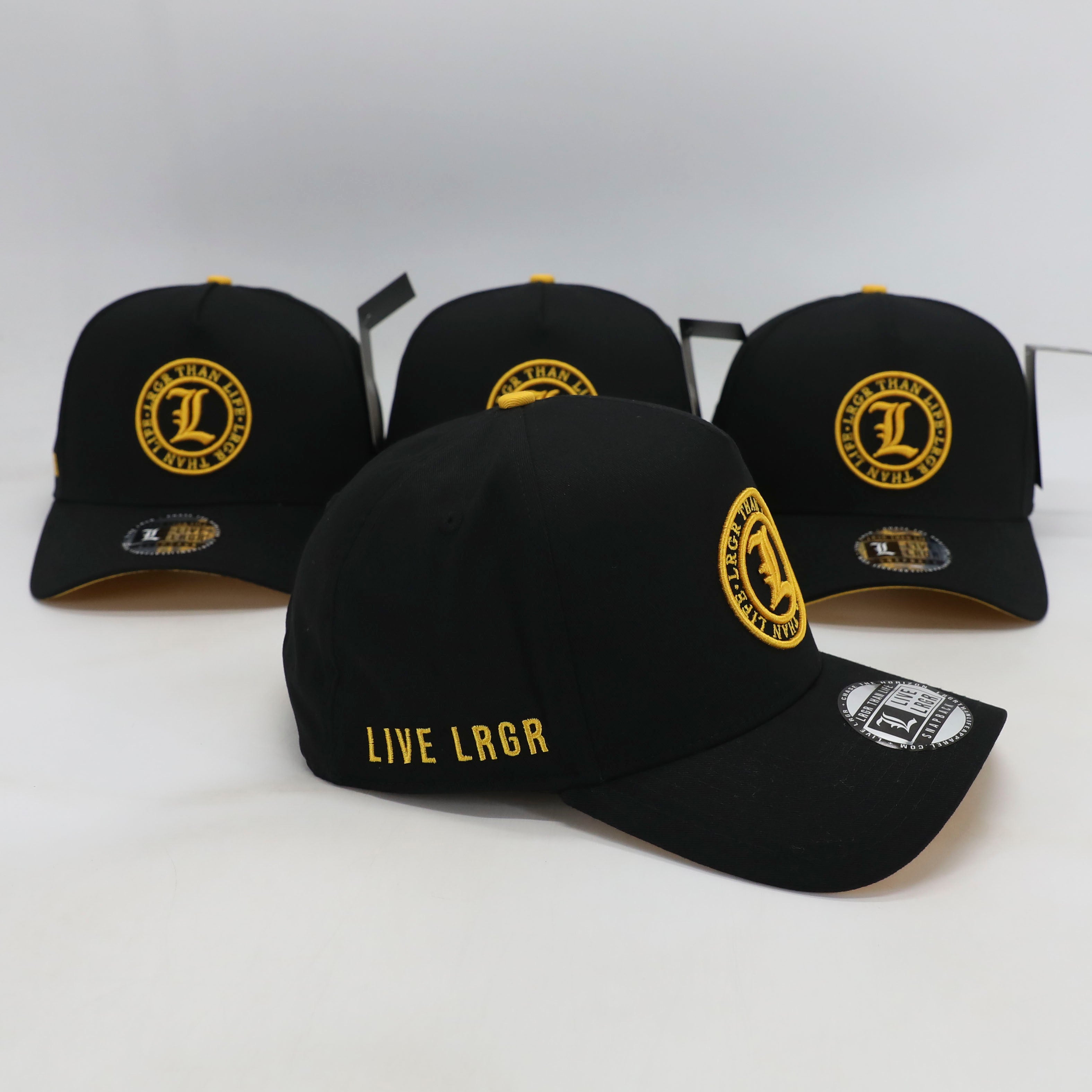 Black baseball caps with yellow logos and text on a white background
