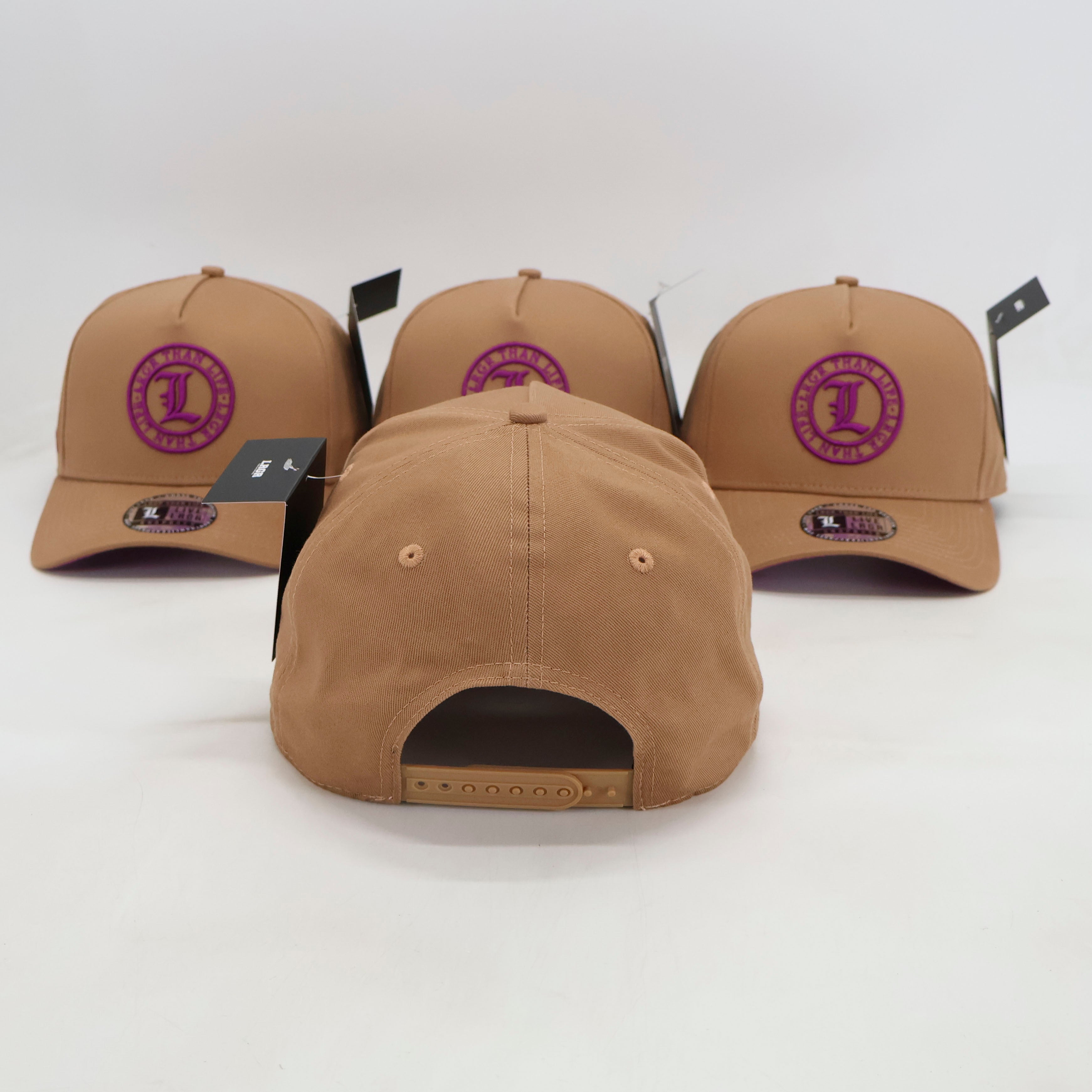 Three tan baseball caps with a purple logo on a white background