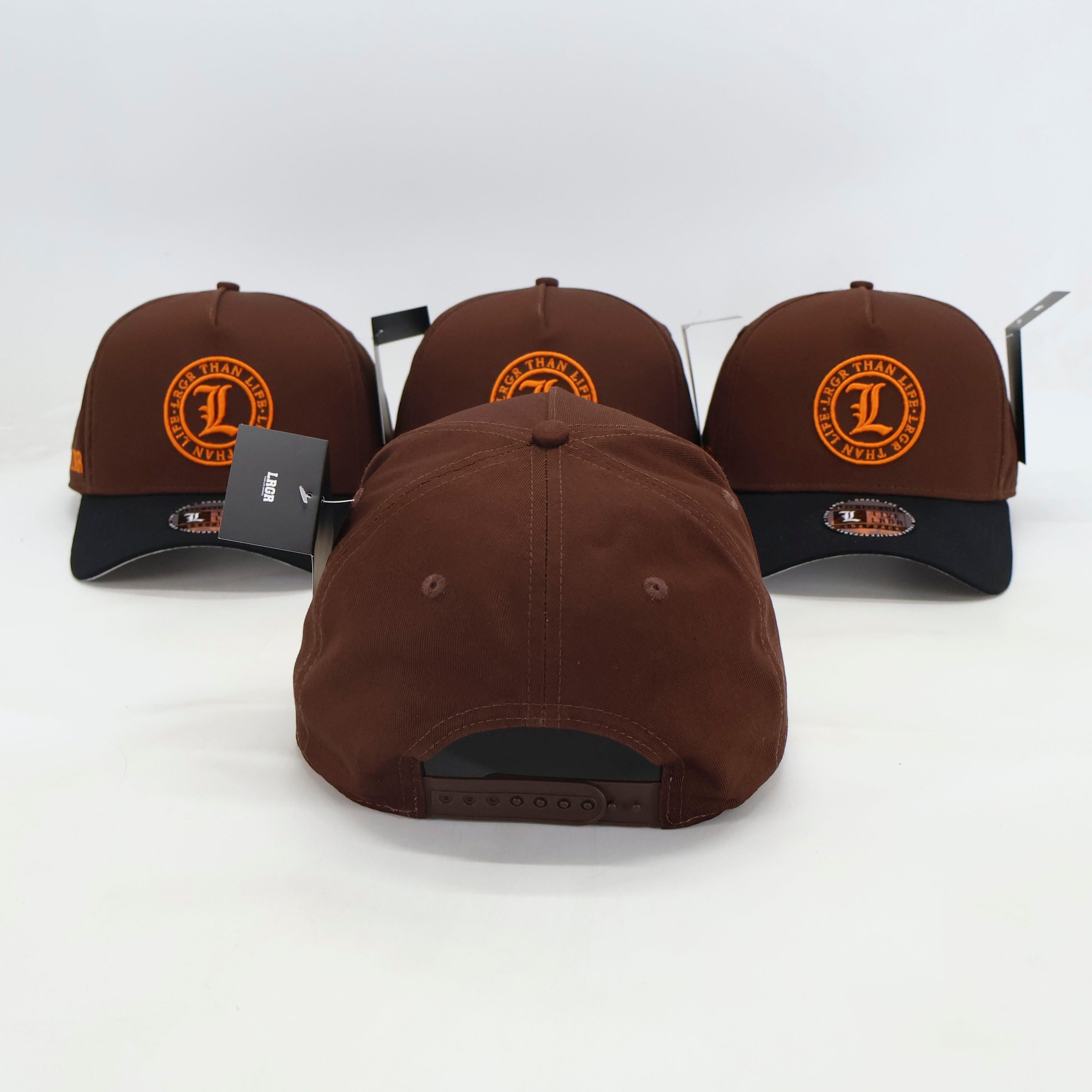 Three brown and black baseball caps with a logo on a white background