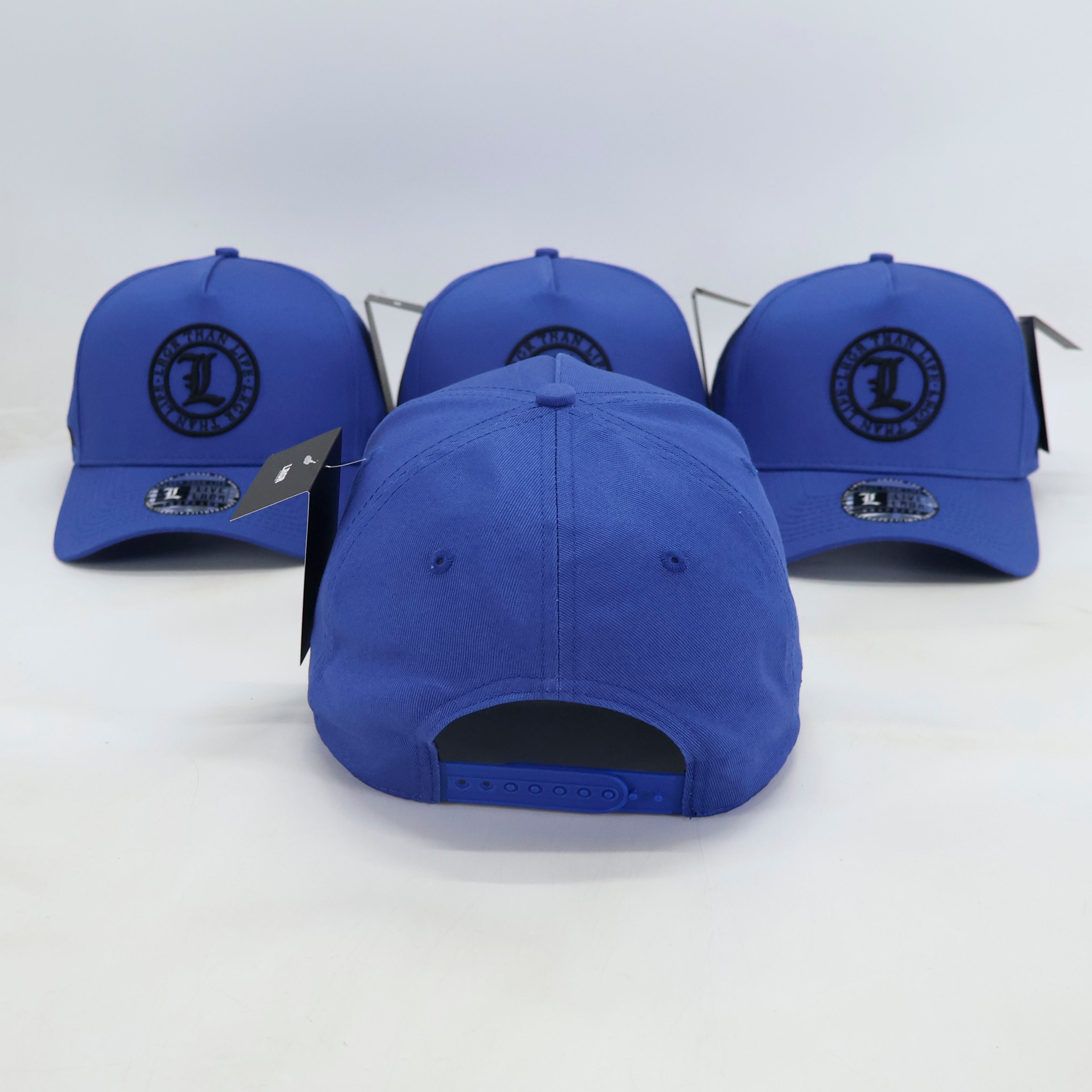 Three blue baseball caps with a logo on a white background
