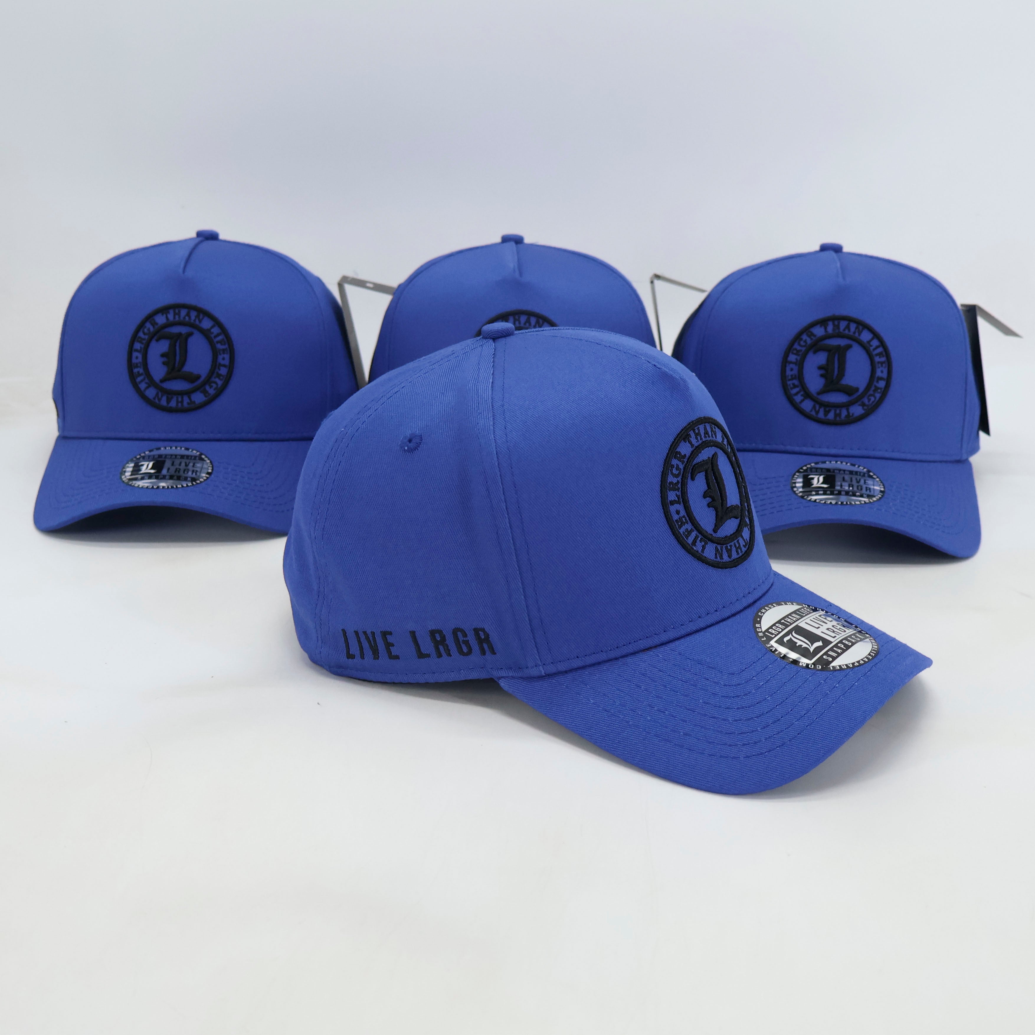 Three blue baseball caps with branding on a white background
