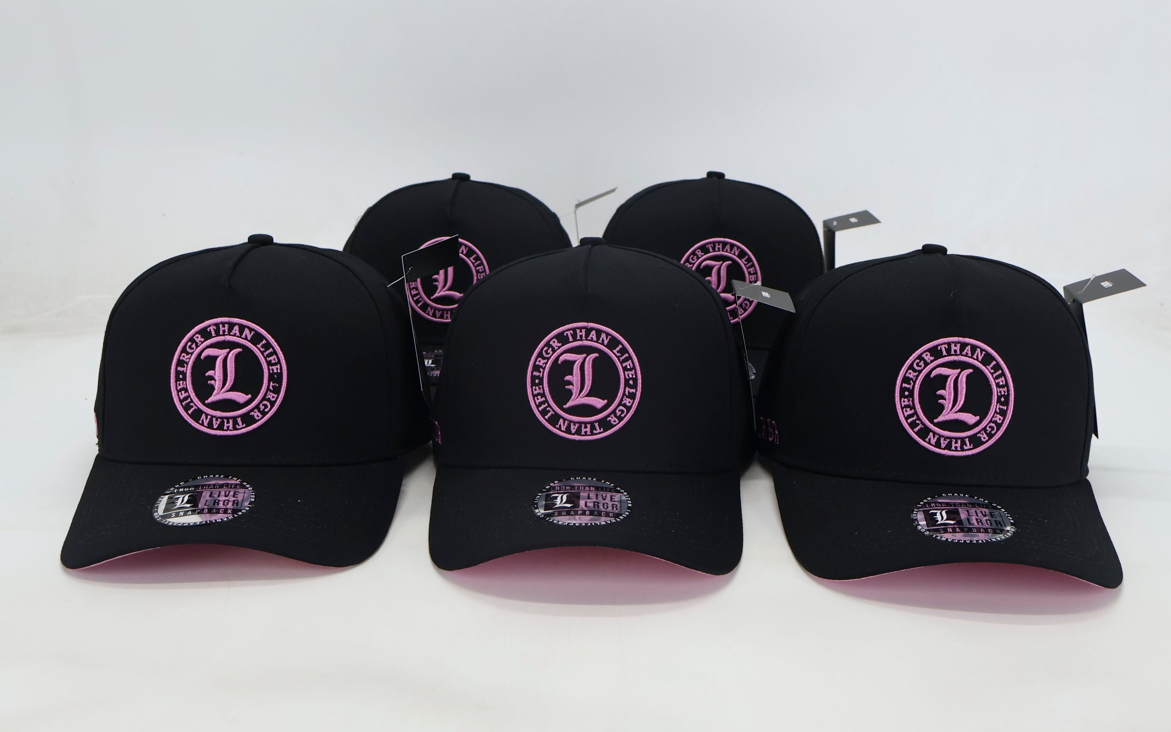 Five black baseball caps with a pink logo on a white background