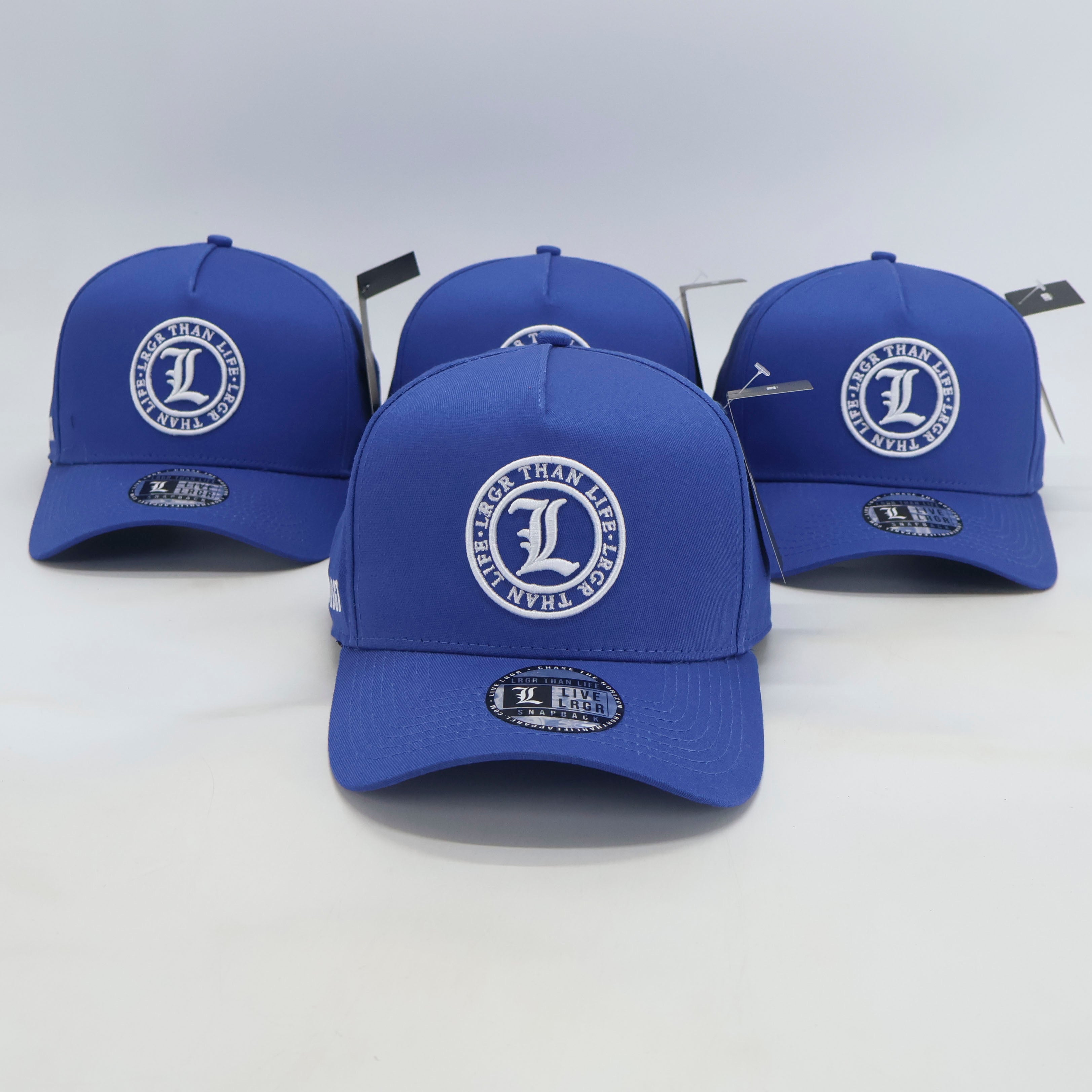 Four blue baseball caps with a logo on a white background