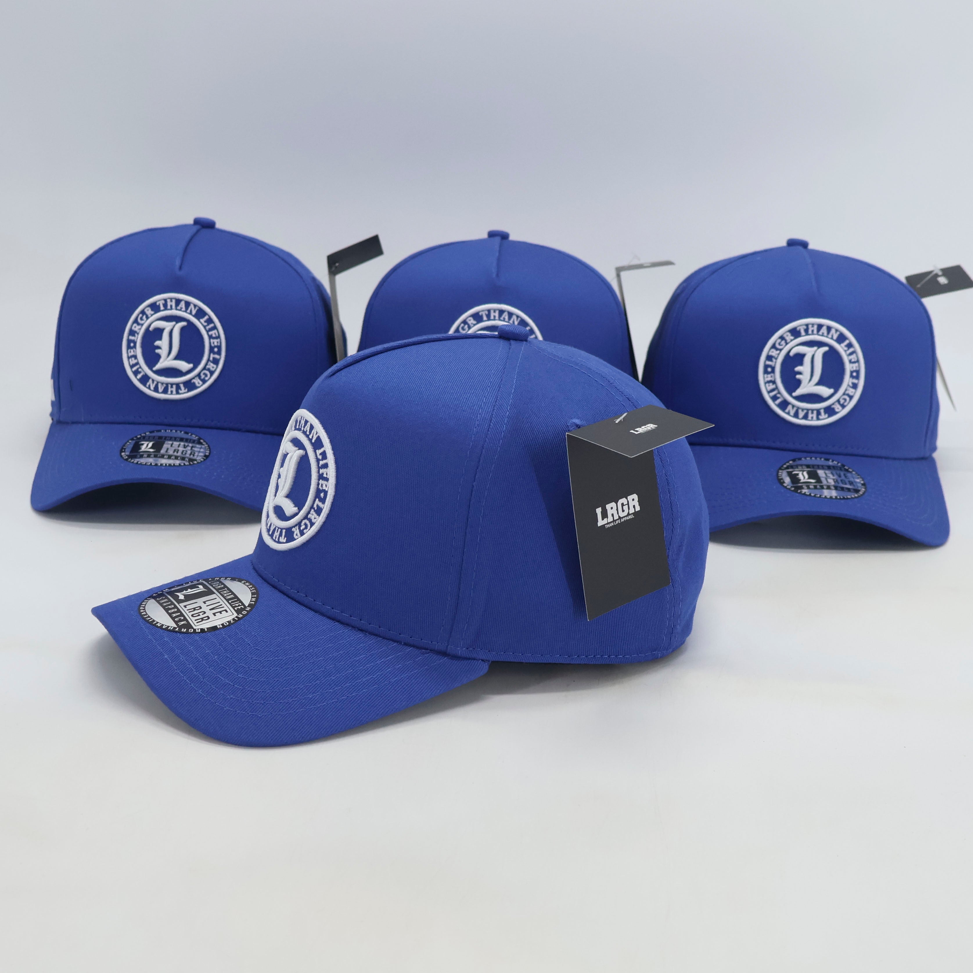 Four blue baseball caps with a logo on a white background