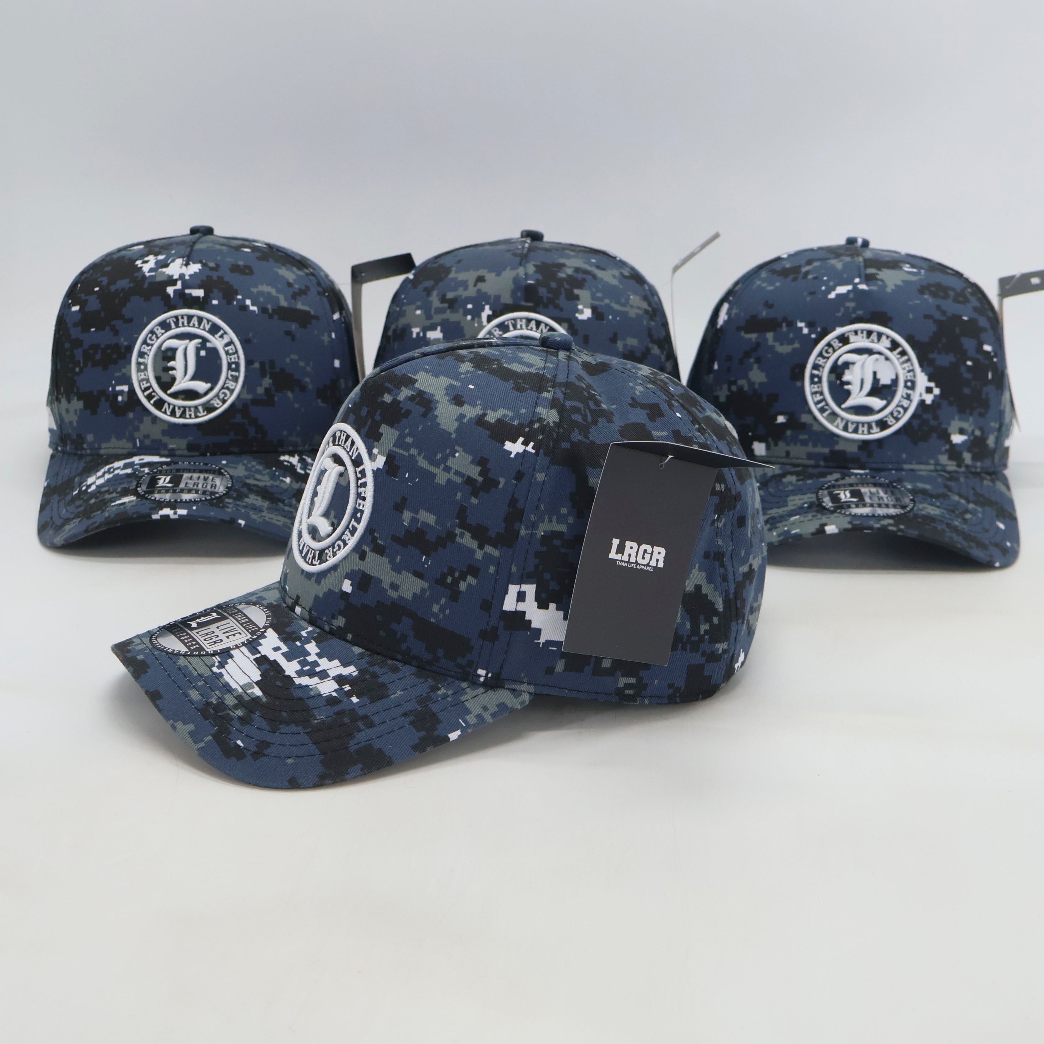 Four navy blue camouflage baseball caps with logos on a white background