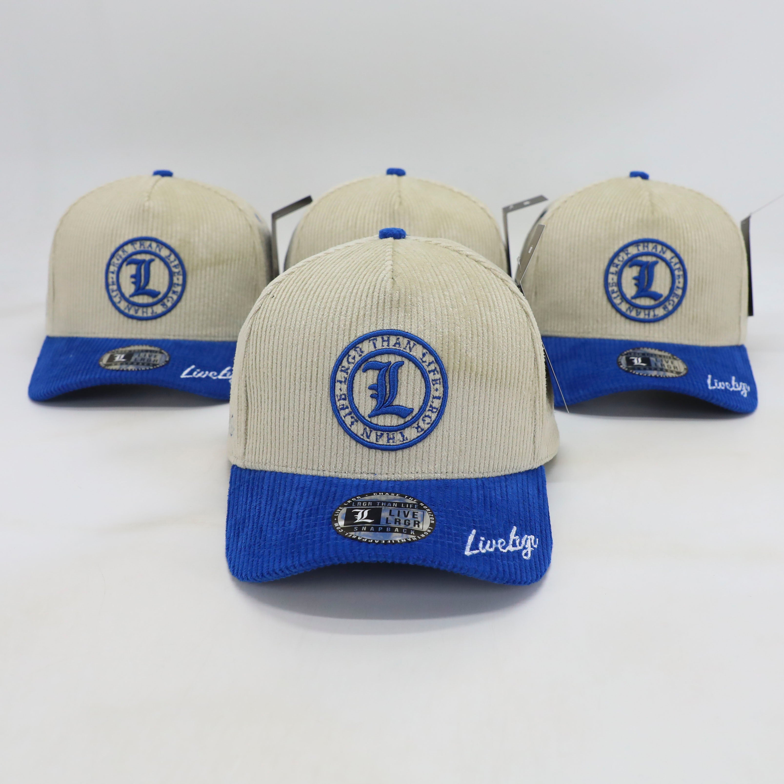 Three baseball caps with blue and beige design on a white background