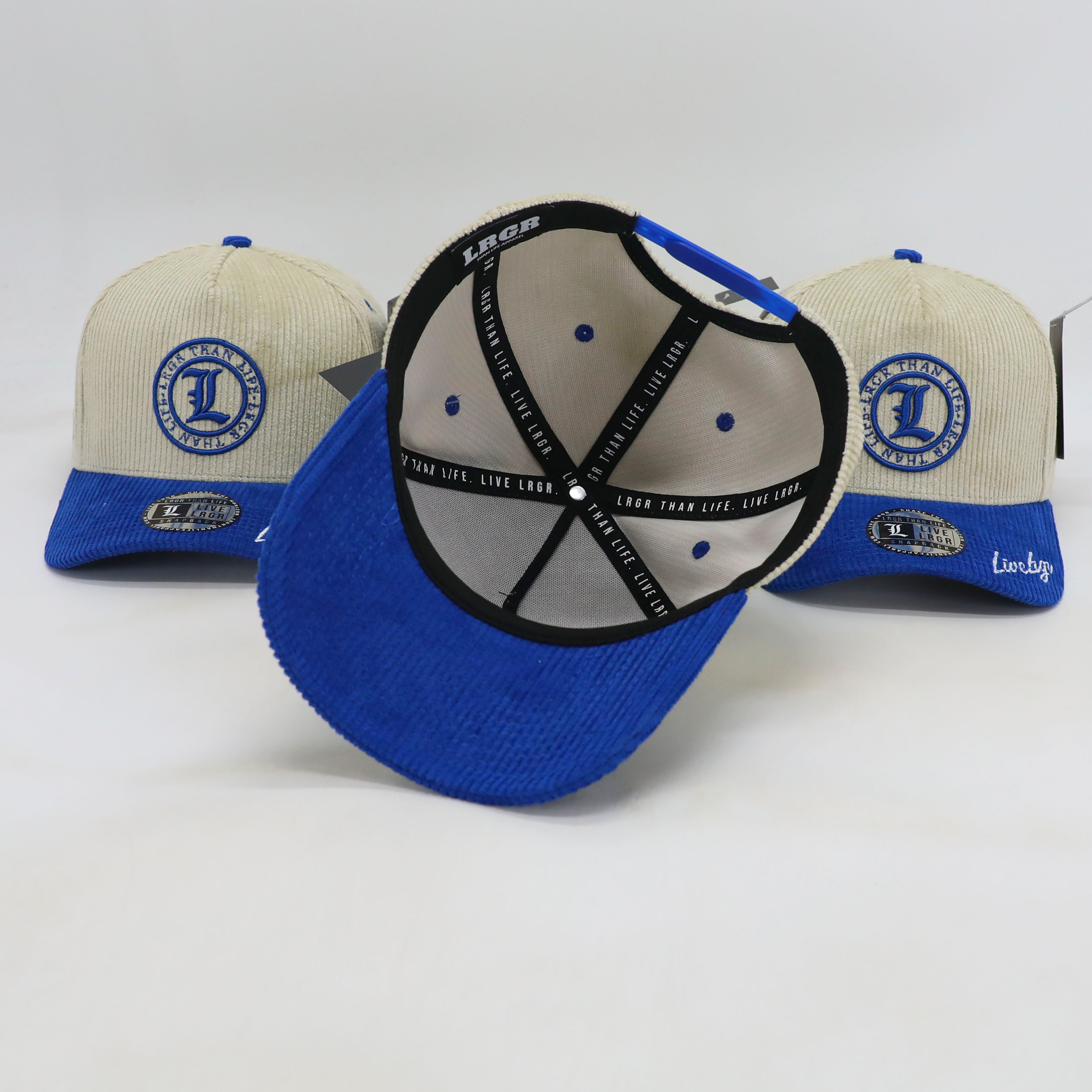 Three baseball caps with blue and beige design on a white background
