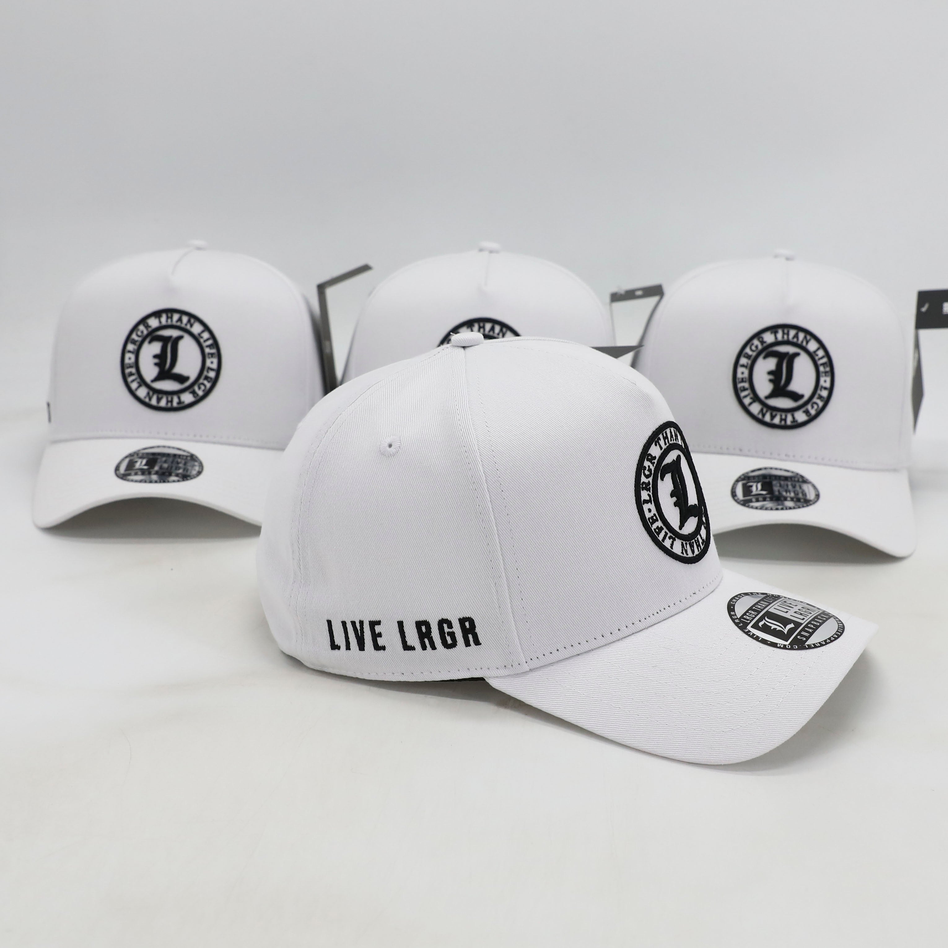 White baseball caps with black logos and text on a light gray background