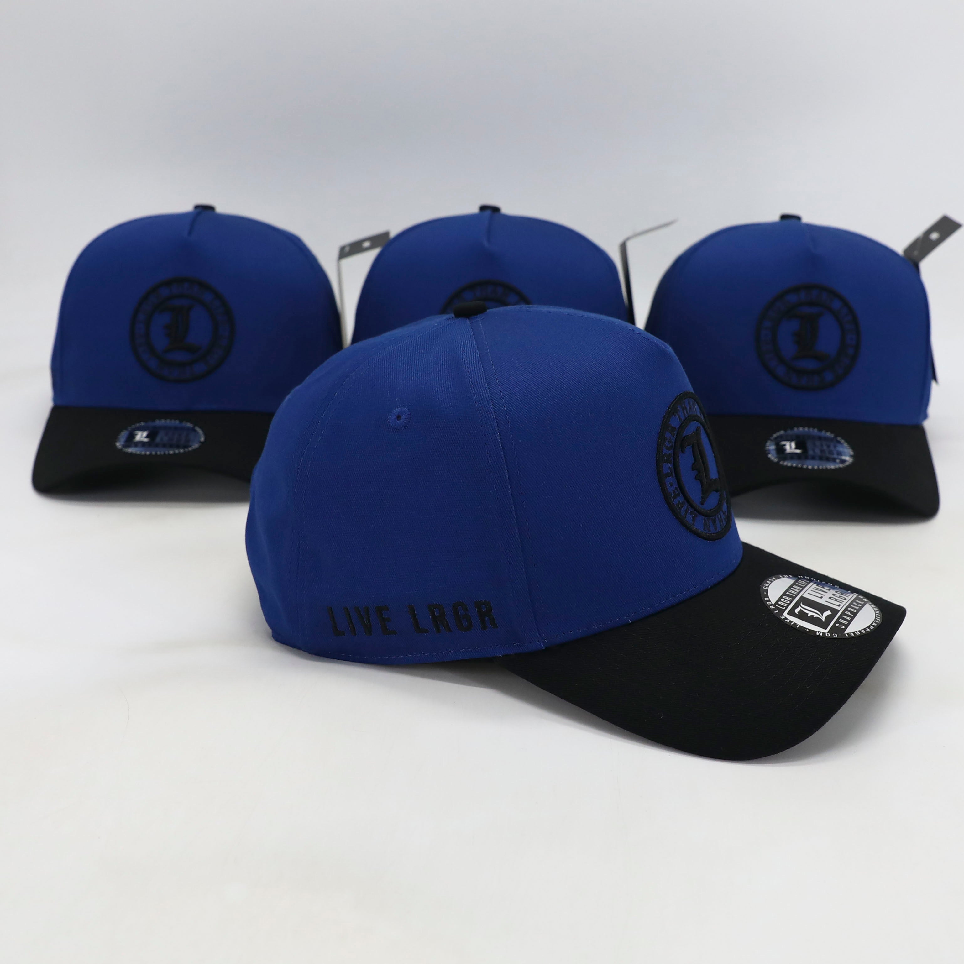 Blue and black caps with visible branding on a white background