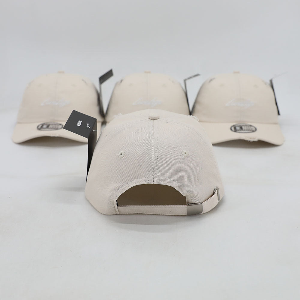 A collection of beige dad hats with a brand tag on the brim.