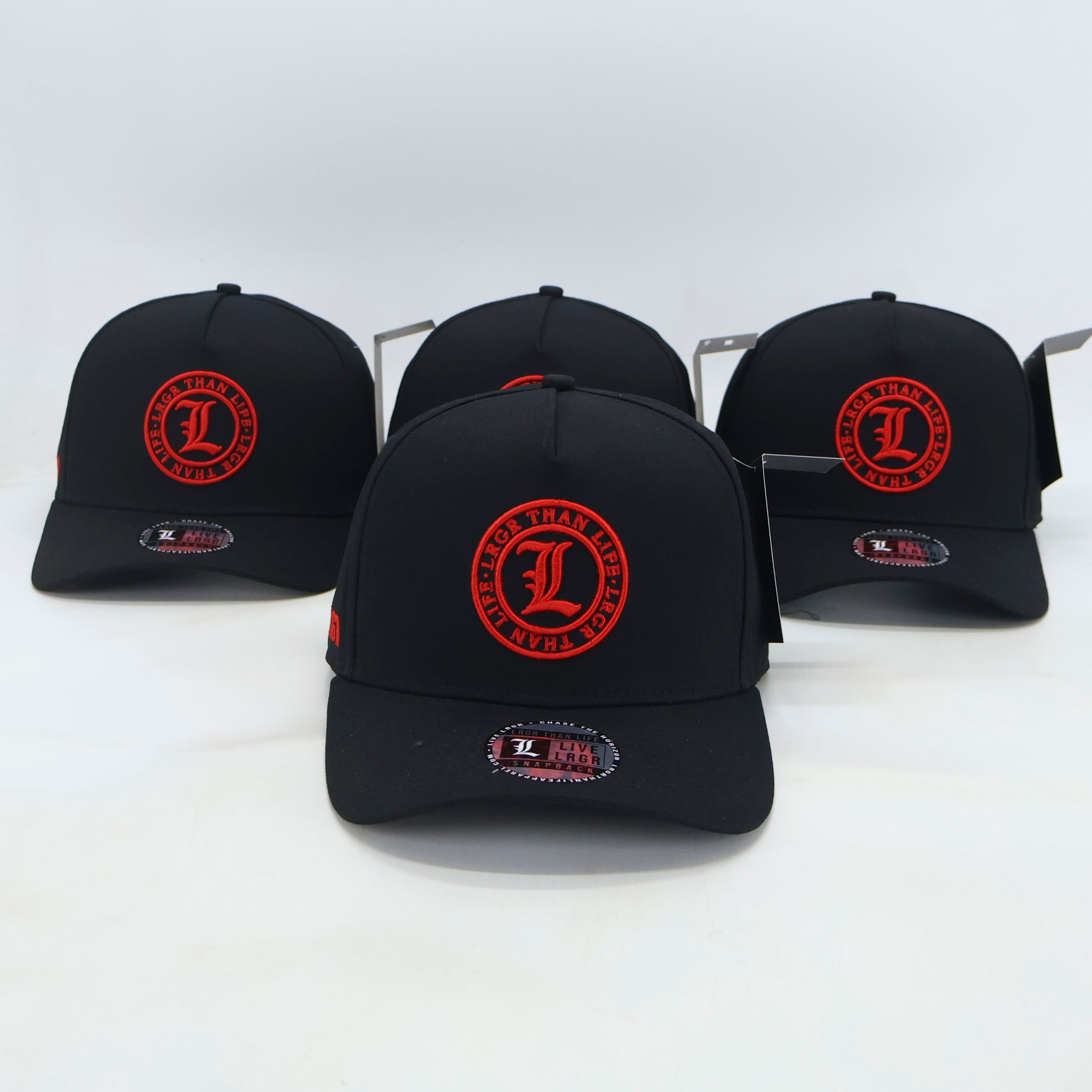 Four black baseball caps with red logos on a white background