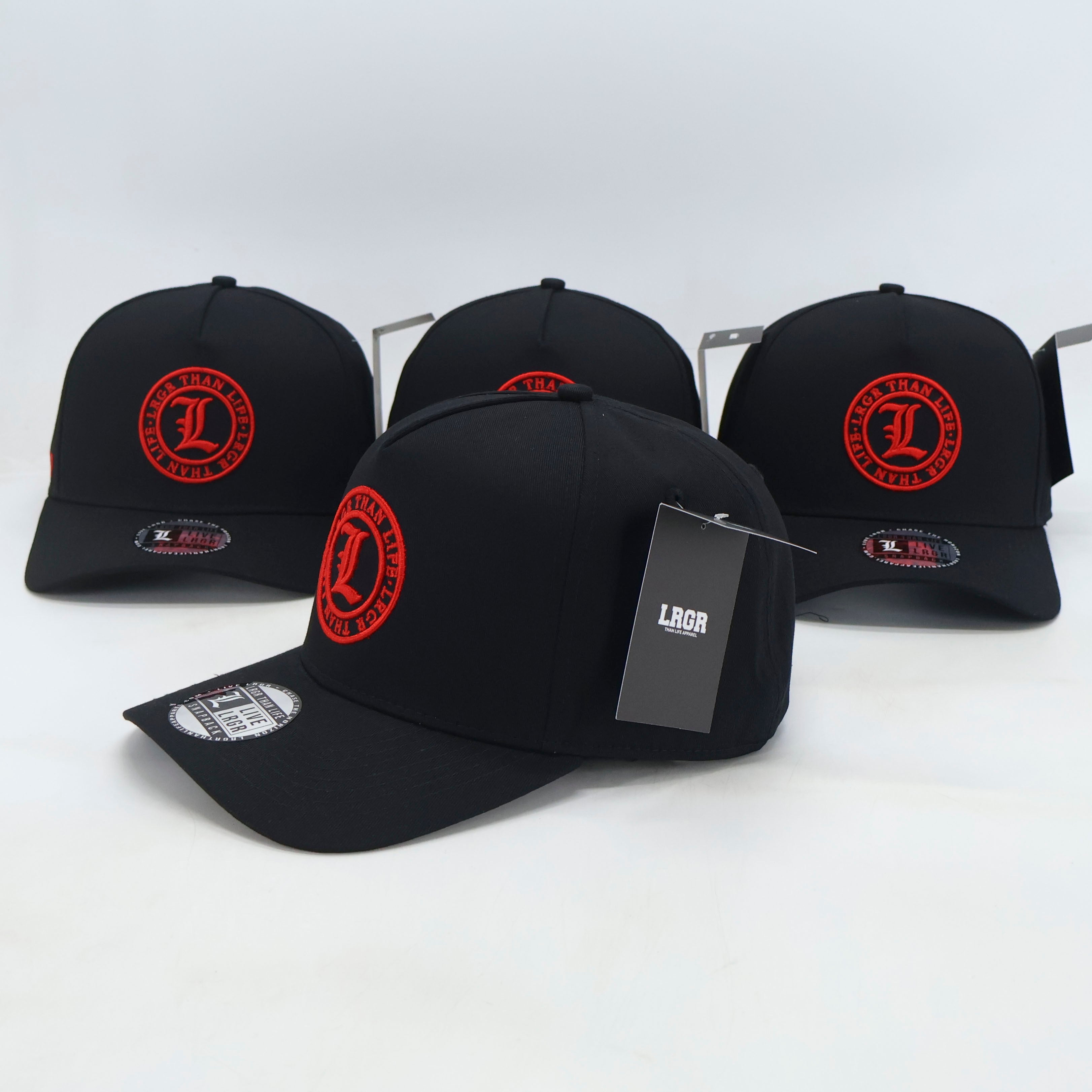 Four black baseball caps with red logos on a white background