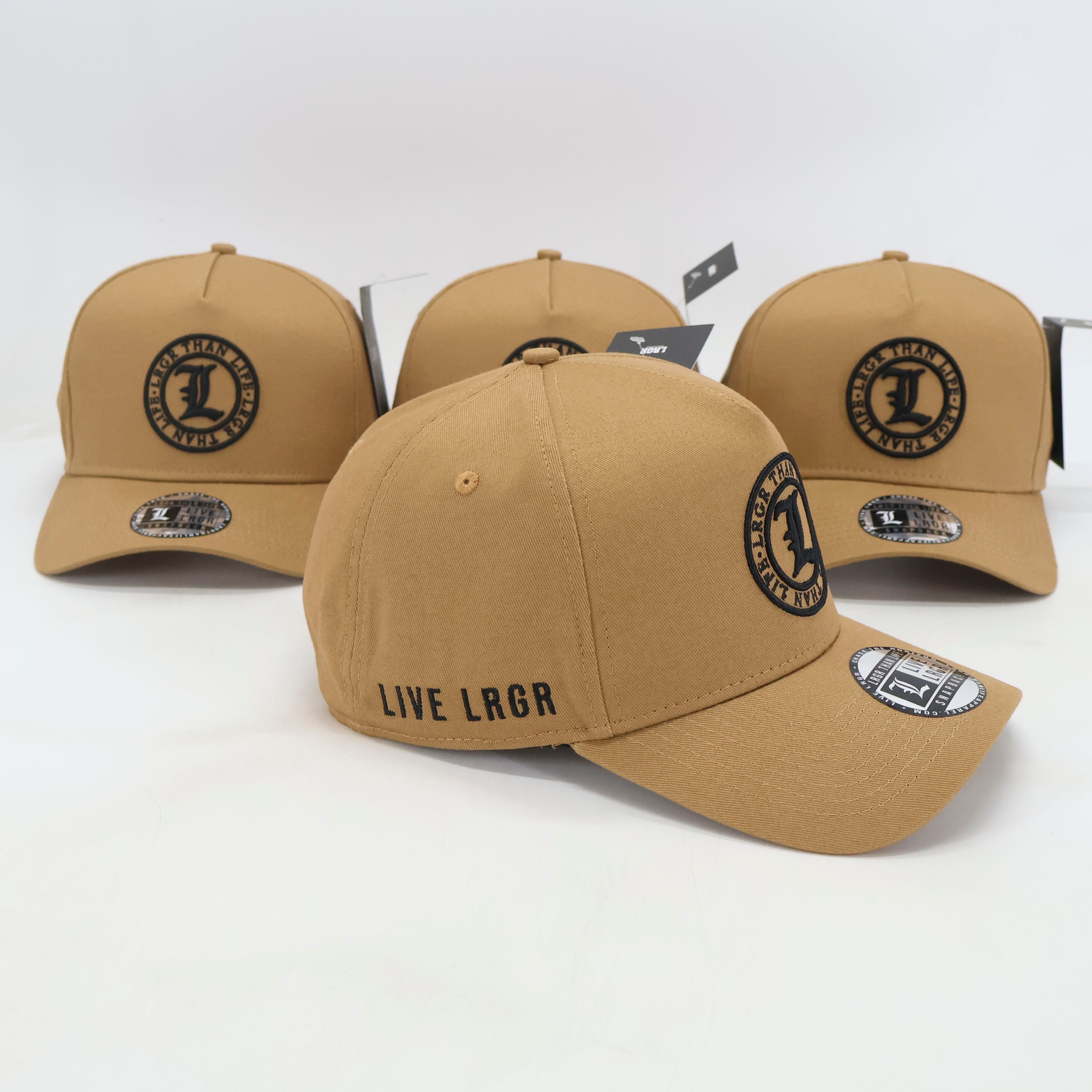 Three tan baseball caps with branding on a white background