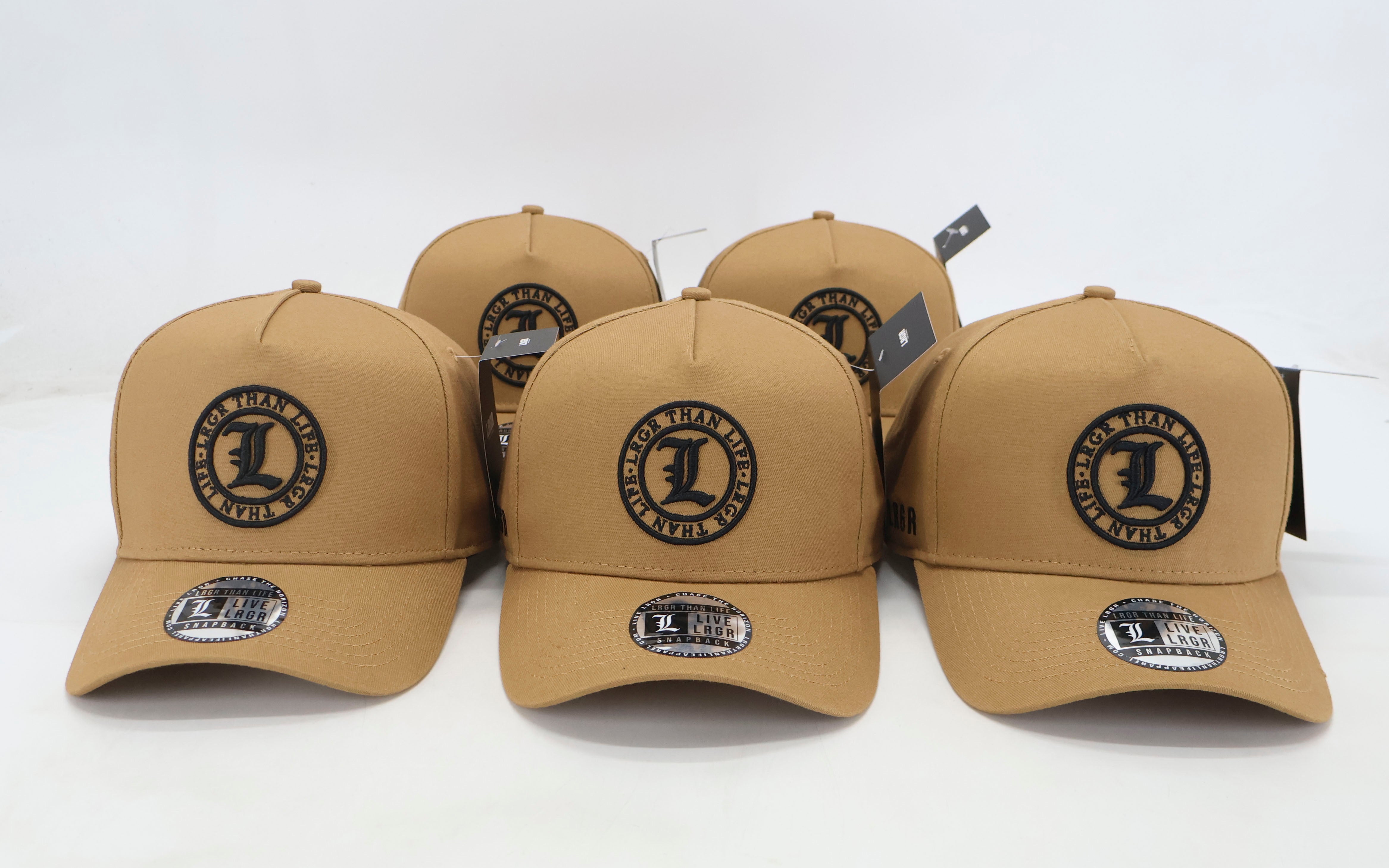 Set of tan baseball caps with a logo on a white background