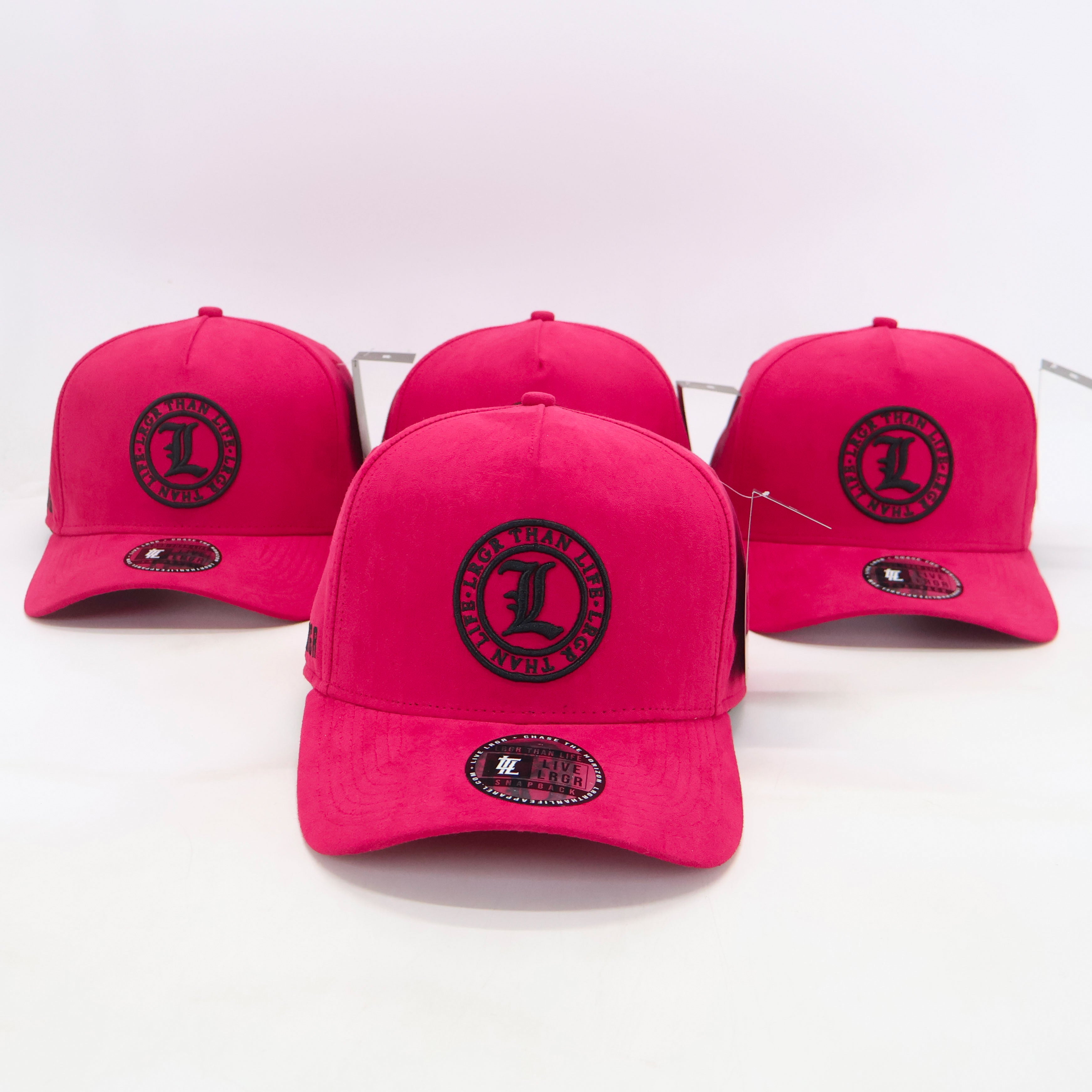 Four pink caps with a black logo on a white background