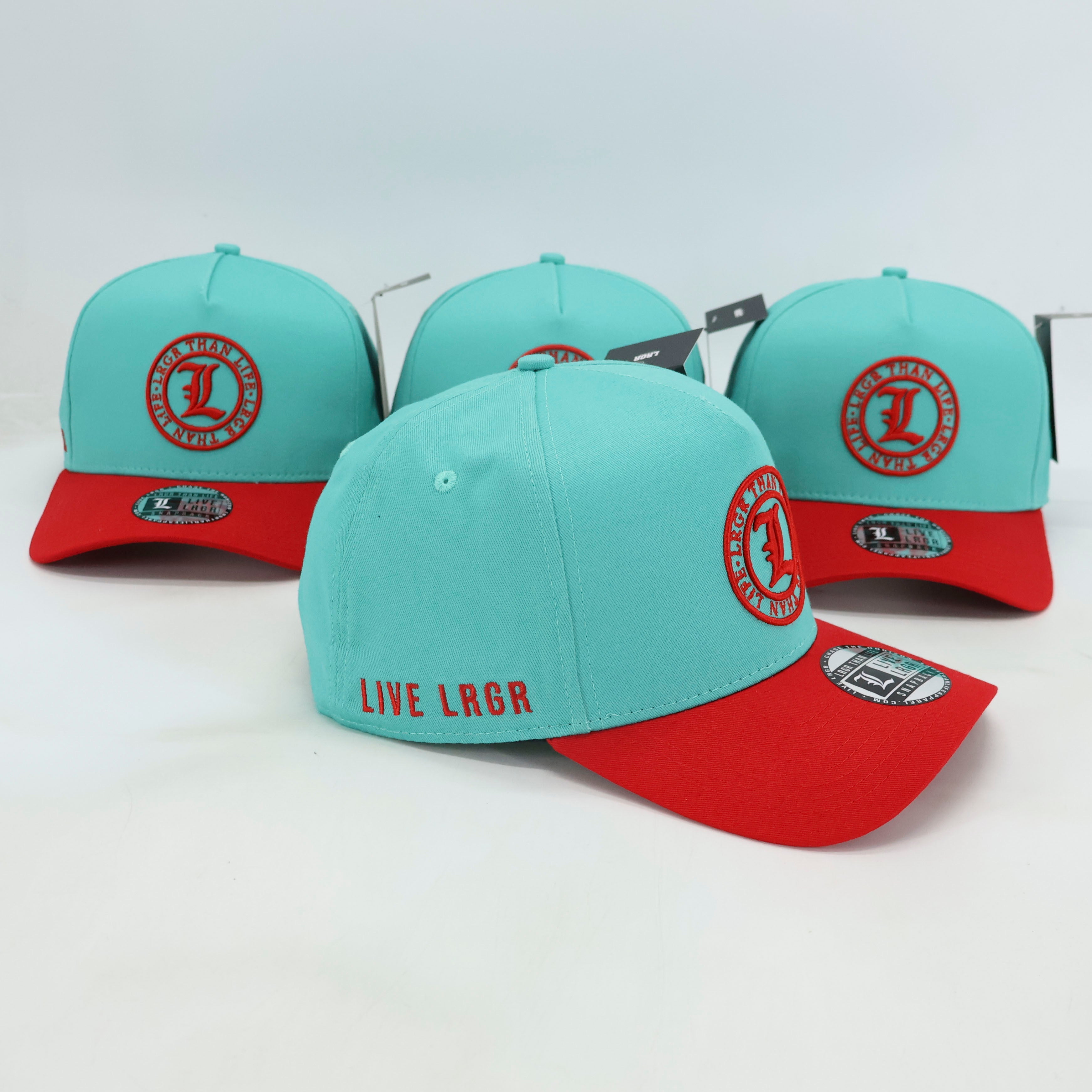 Turquoise and red baseball caps with branding on a white background
