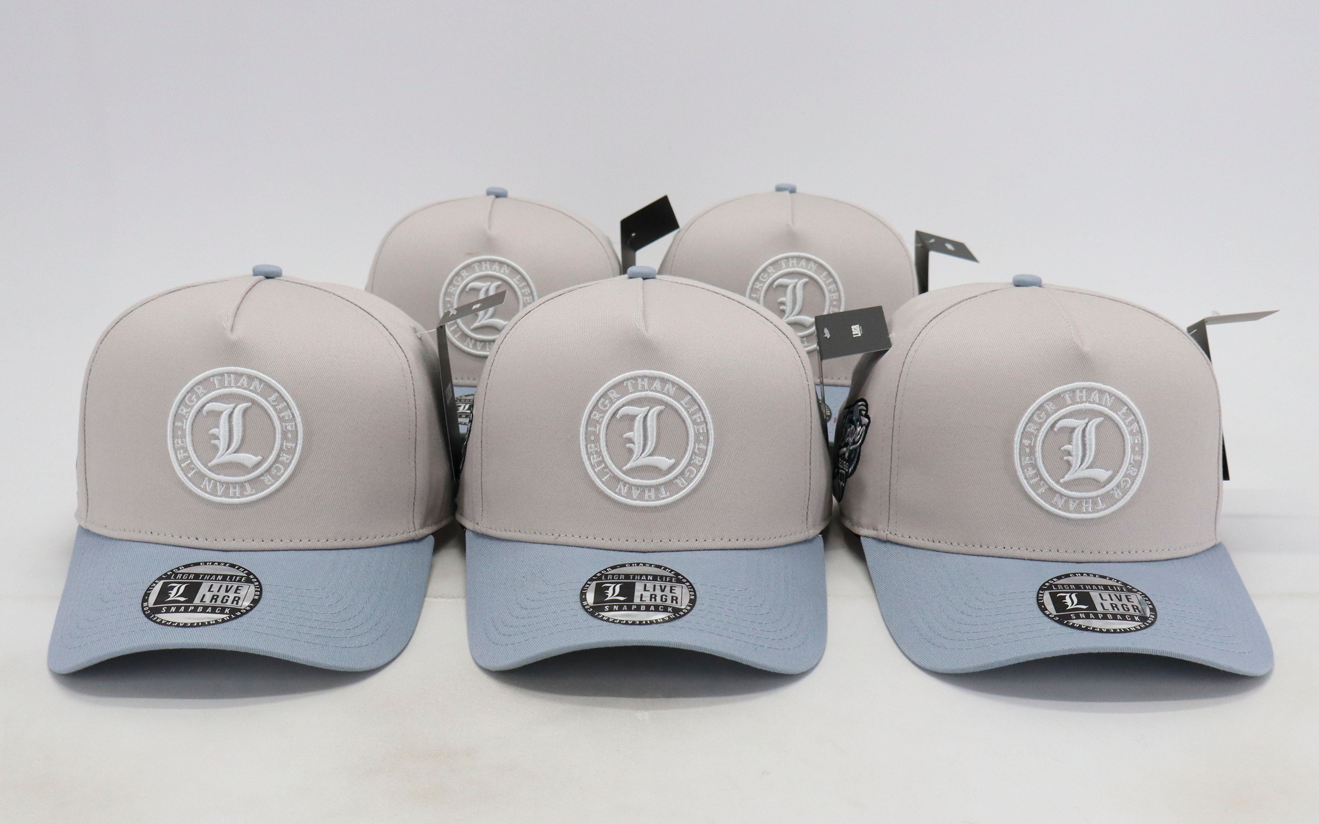 Five gray and blue baseball caps with a logo on a white background