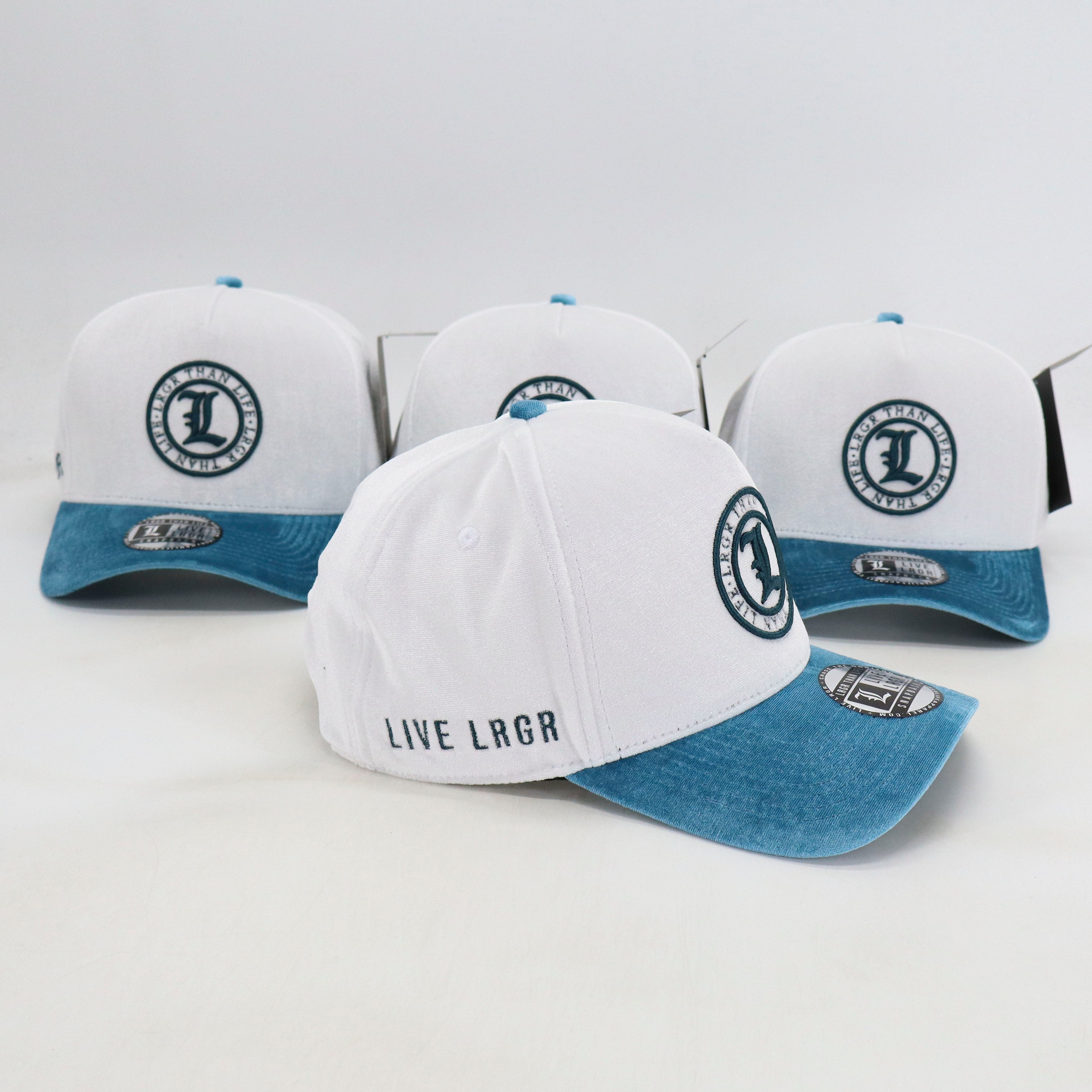 White and blue baseball caps with branding on a light gray background