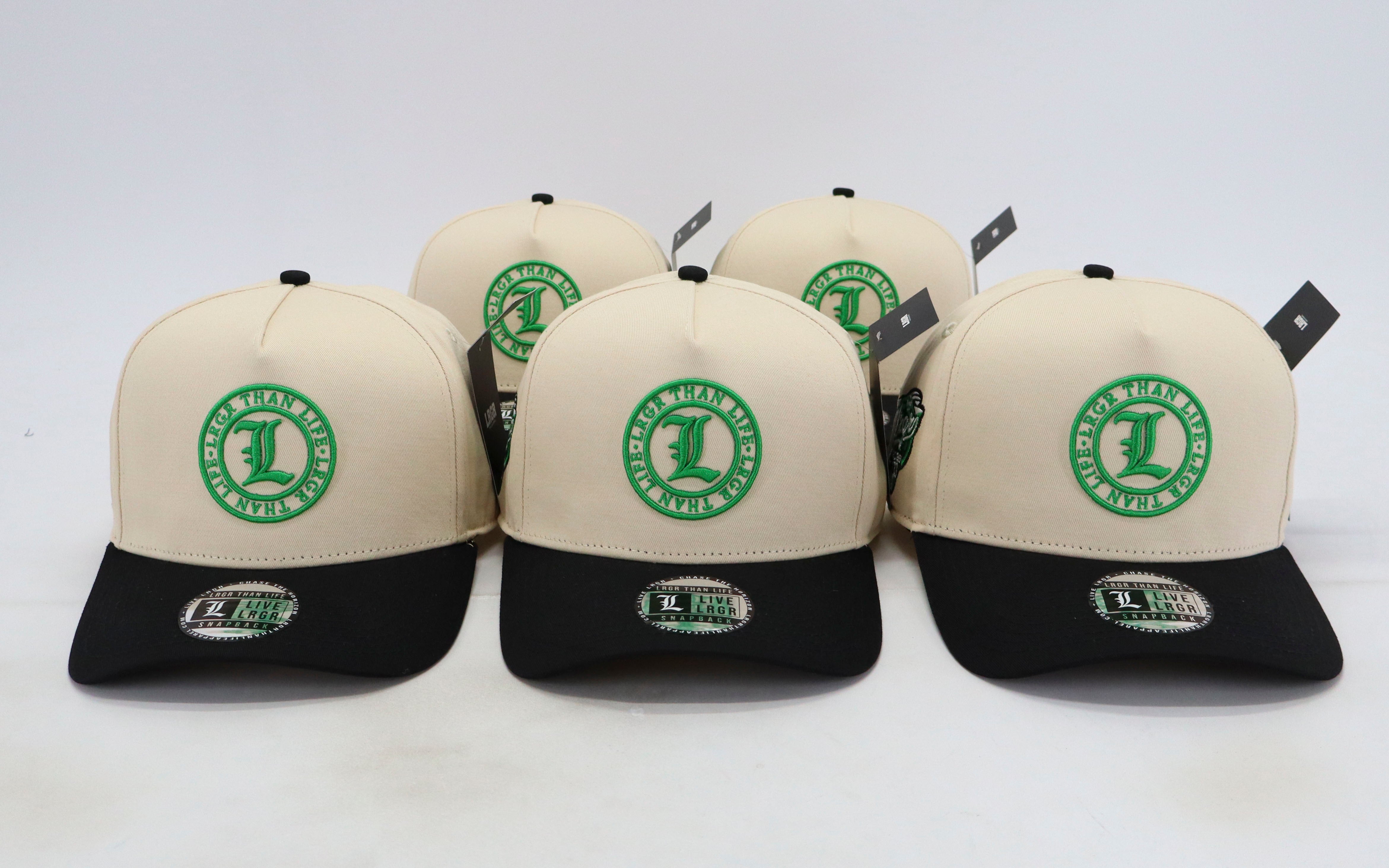 Four caps with green logos on a white background