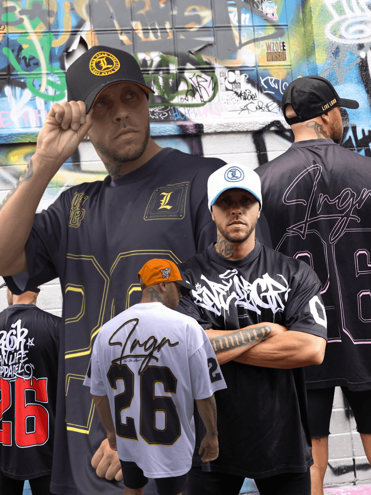People wearing branded t-shirts in front of a graffiti-covered wall