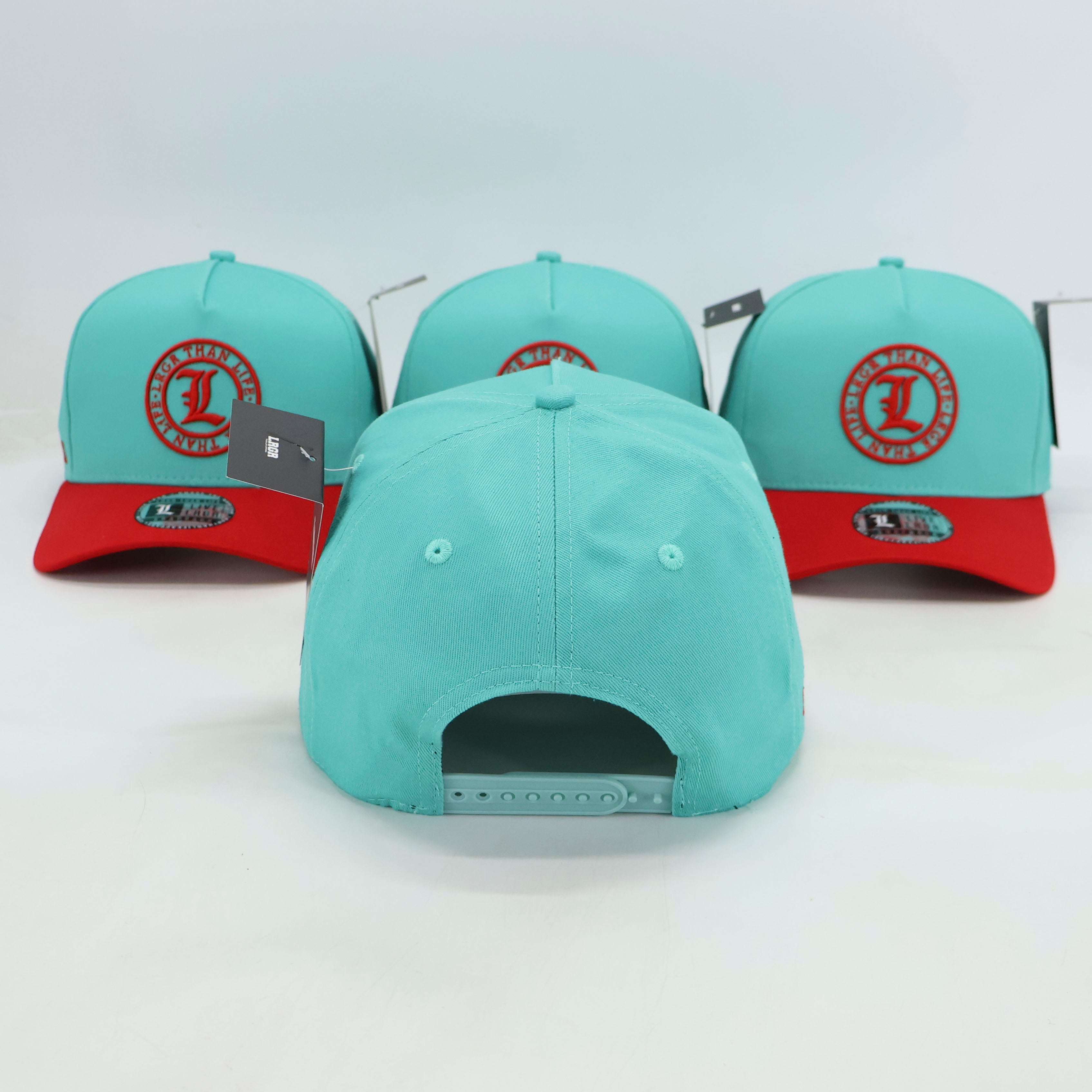 Three turquoise baseball caps with red brims and logos on a white background
