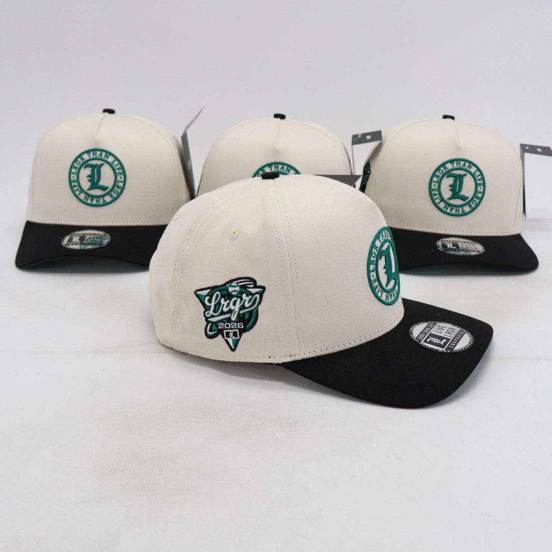 Four baseball caps with logos on a white background