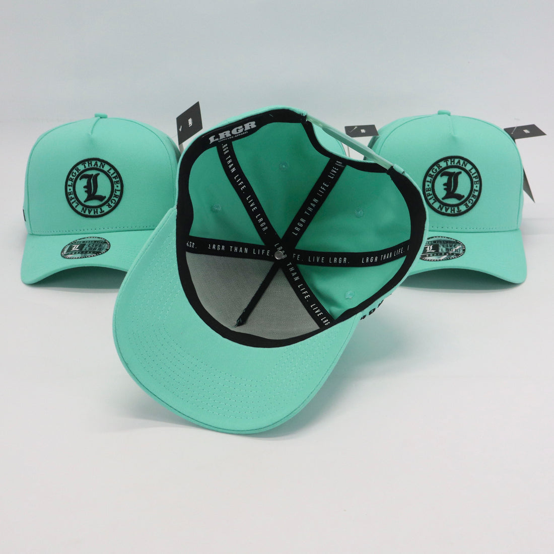 Light blue baseball caps with black branding on a light gray background