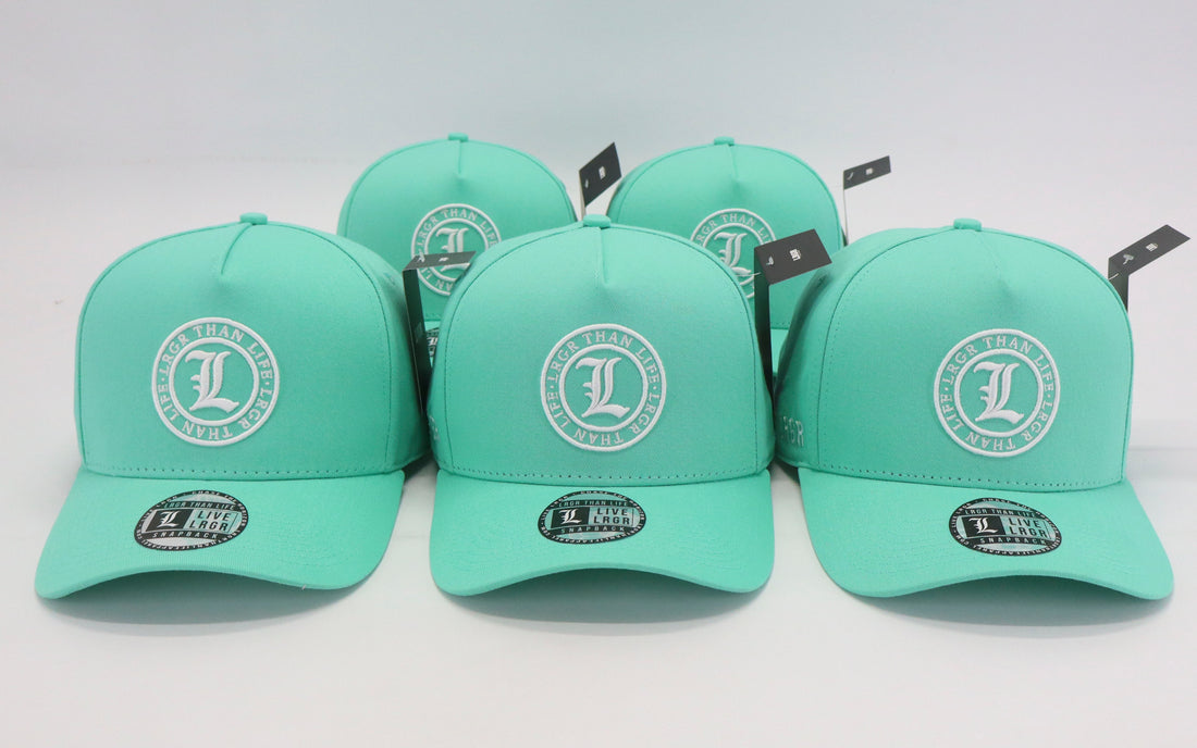 Set of green caps with a logo on a light gray background