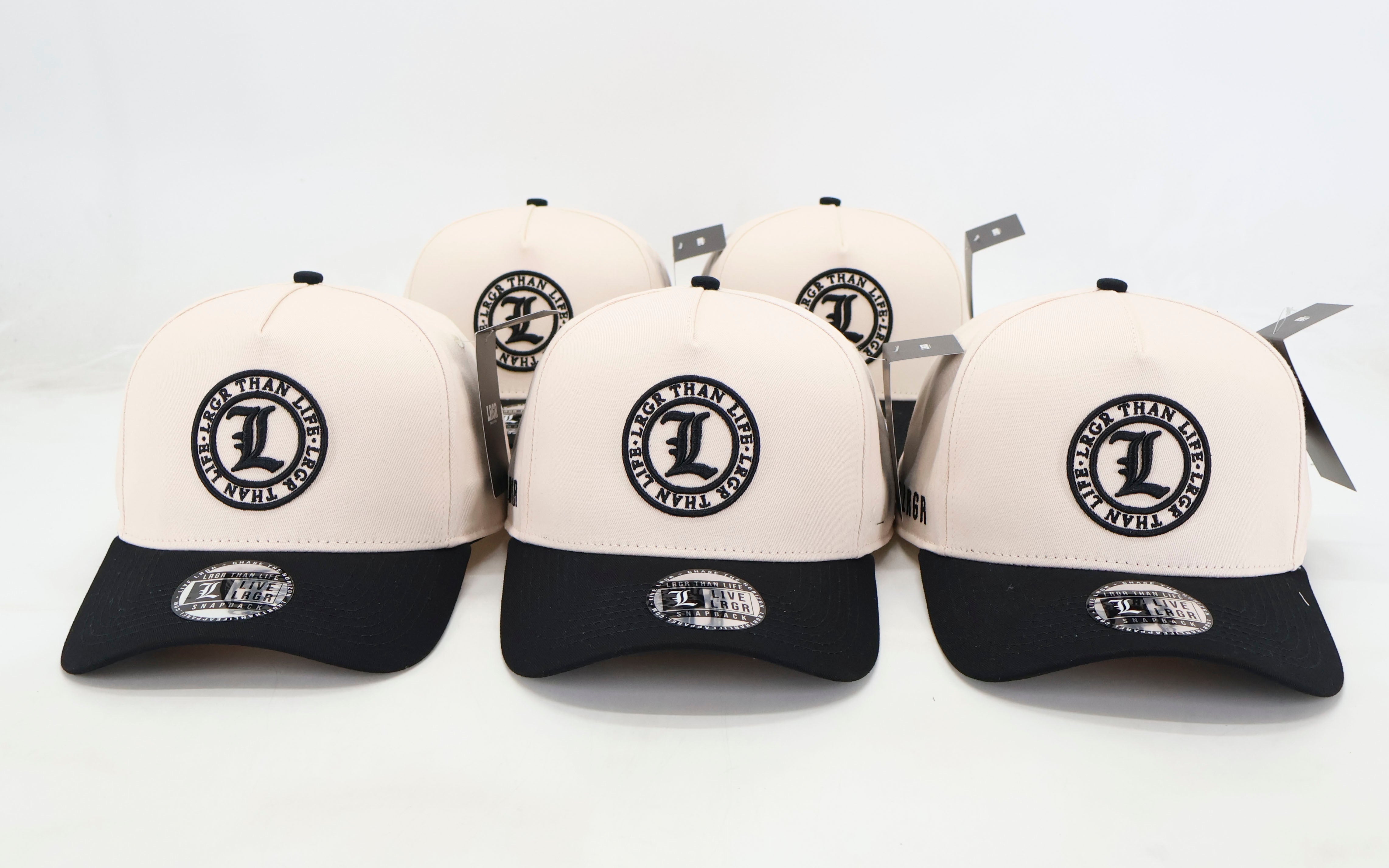 Set of white and black caps with a logo on a light gray background
