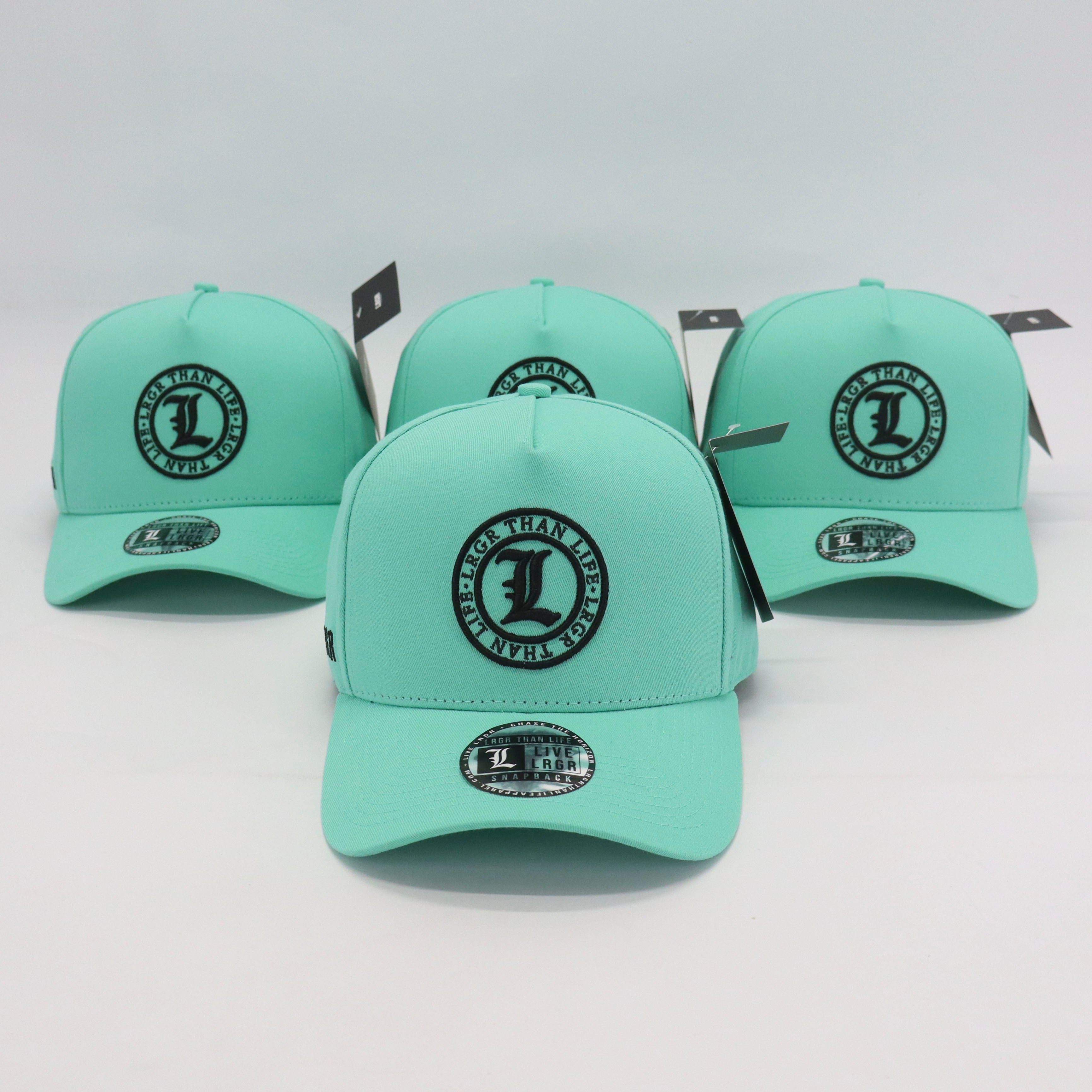 Four mint green caps with black logos on a white background