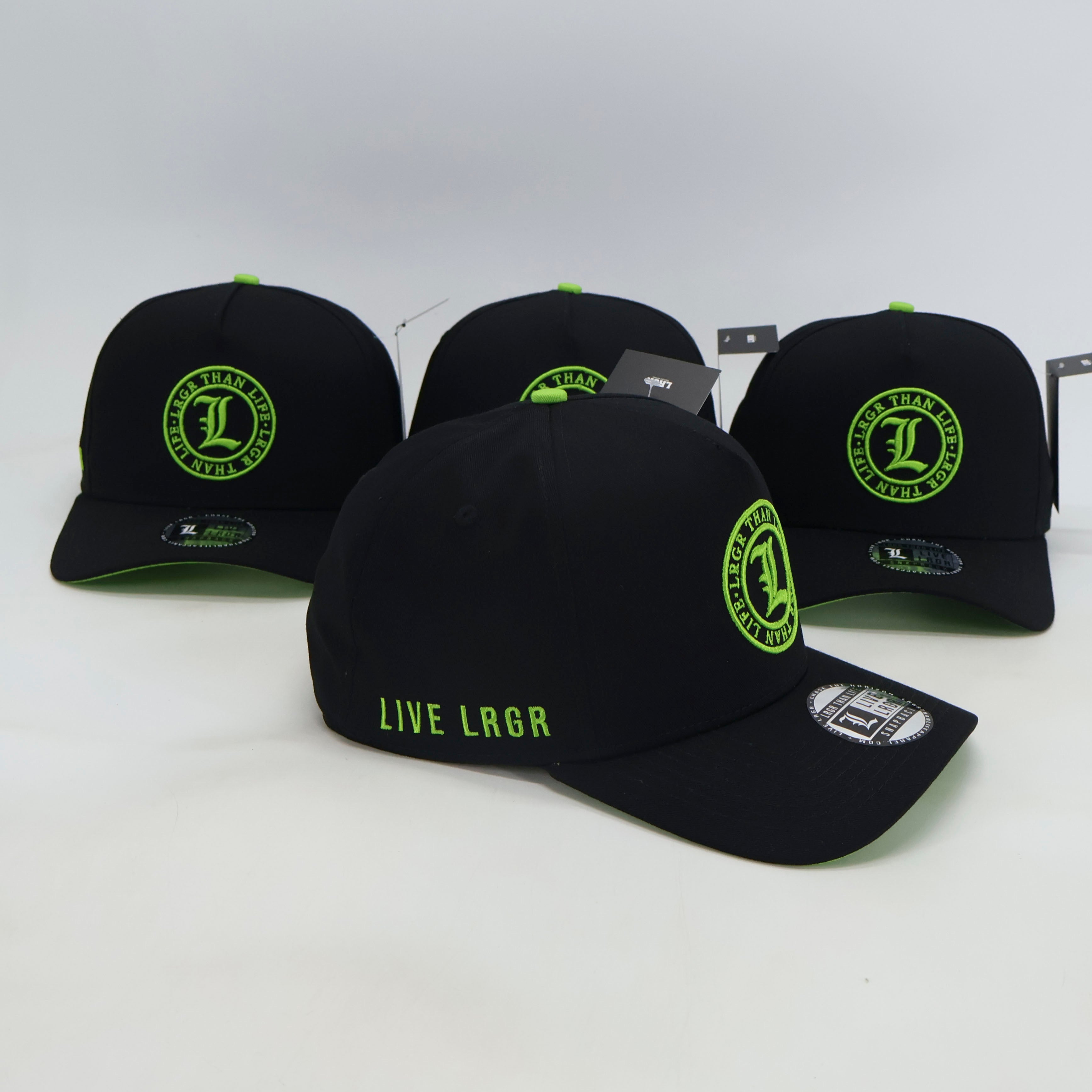 Black baseball caps with green text and logos on a white background