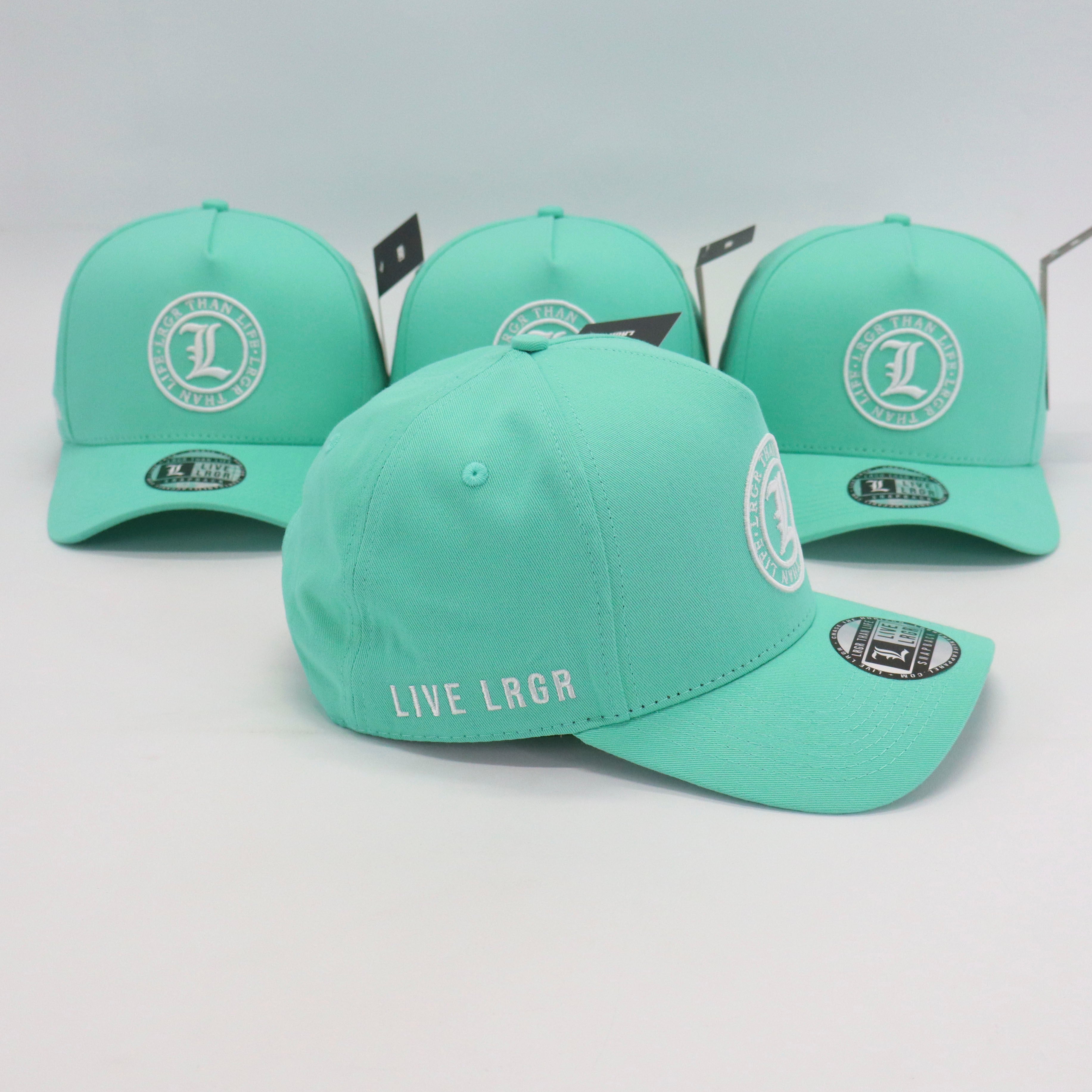Four mint green caps with branding on a light gray background