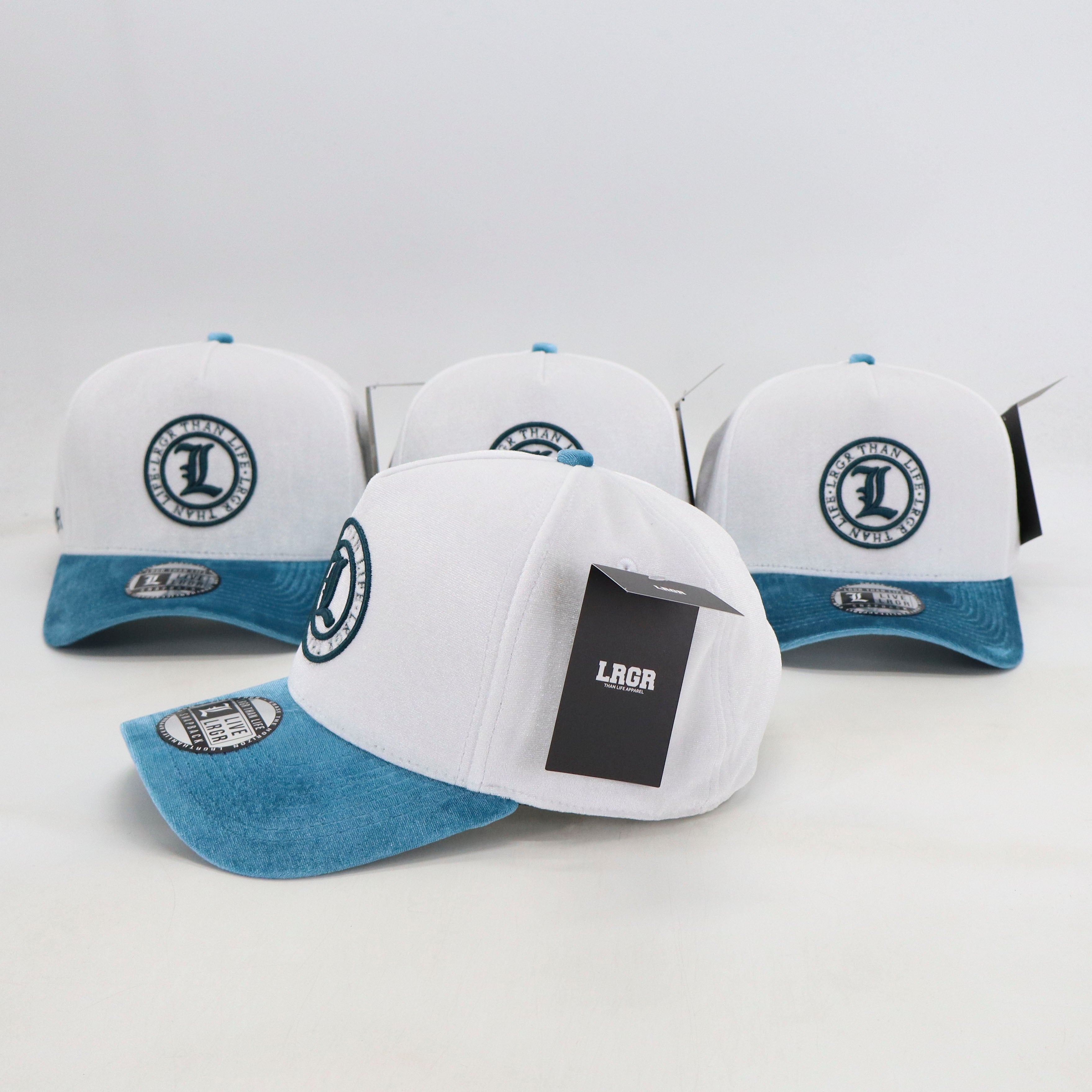 Four white and blue caps with a logo on a light gray background