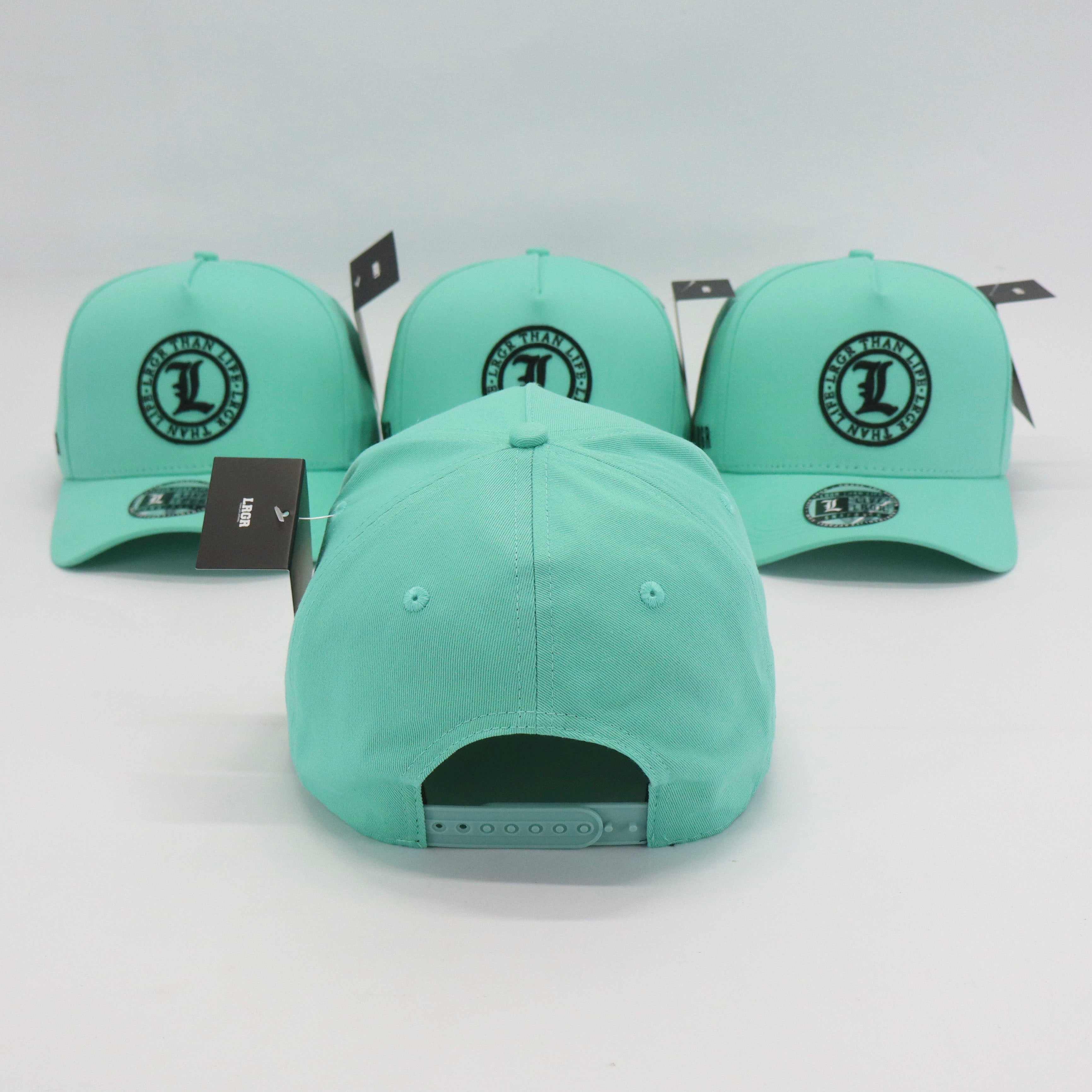 Three mint green baseball caps with a logo on a white background