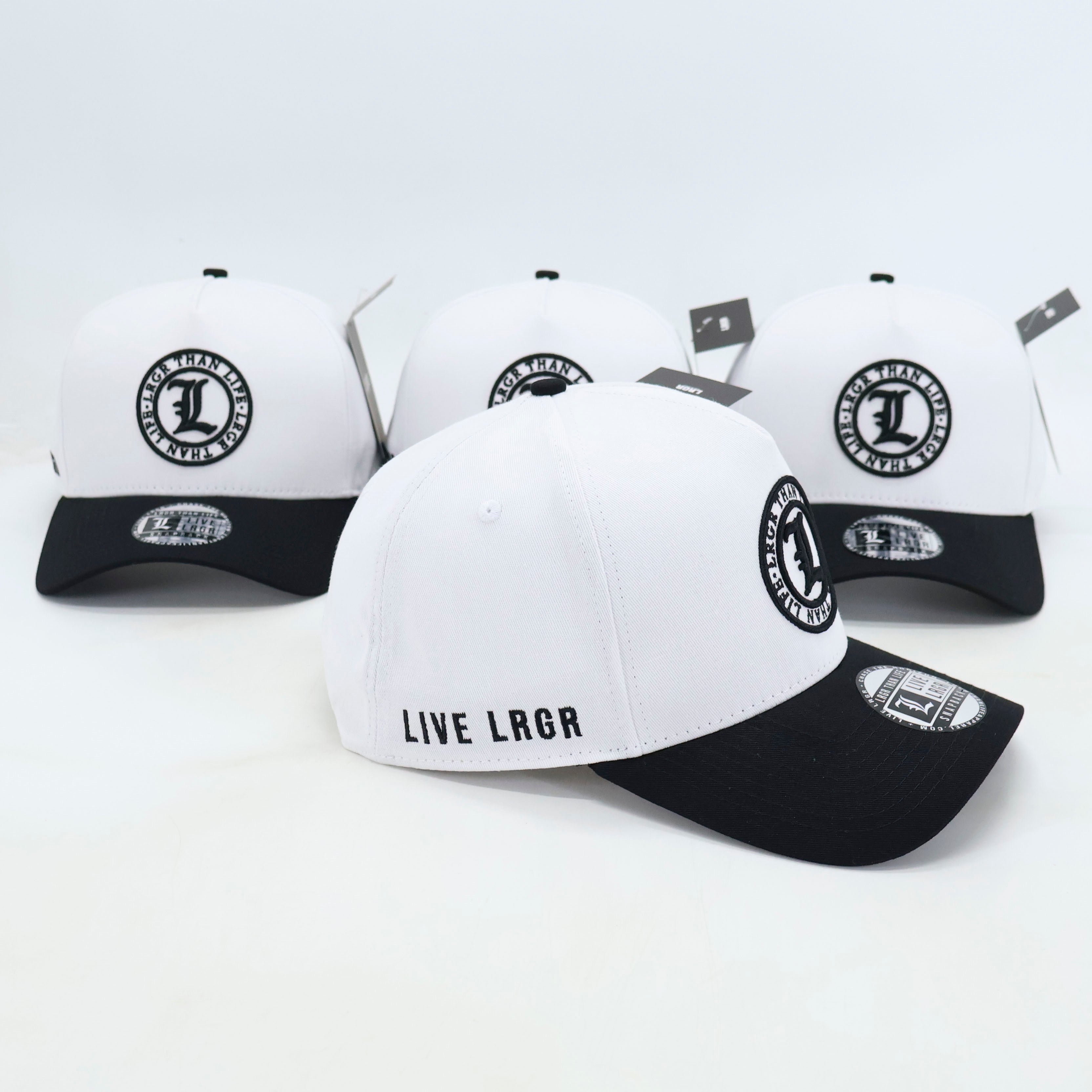 White and black baseball caps with 'LIVE LRGR' text and logo on a white background