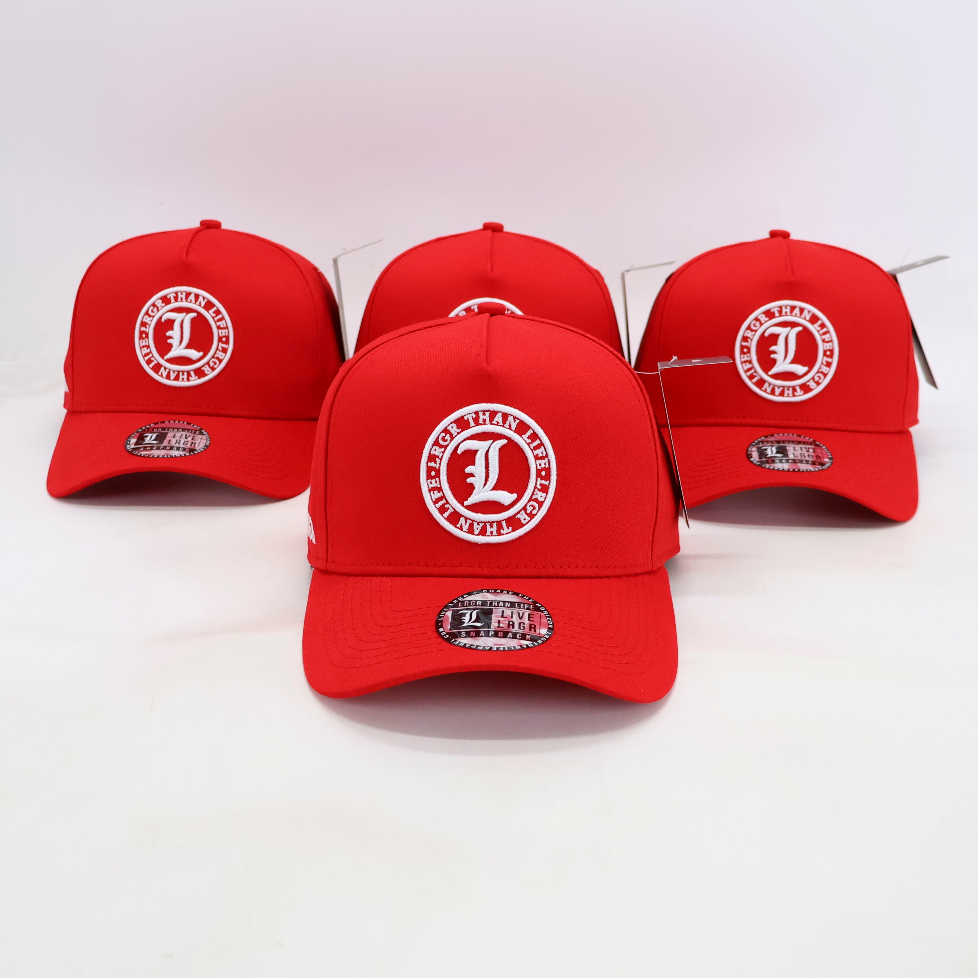 Four red baseball caps with a white logo on a white background
