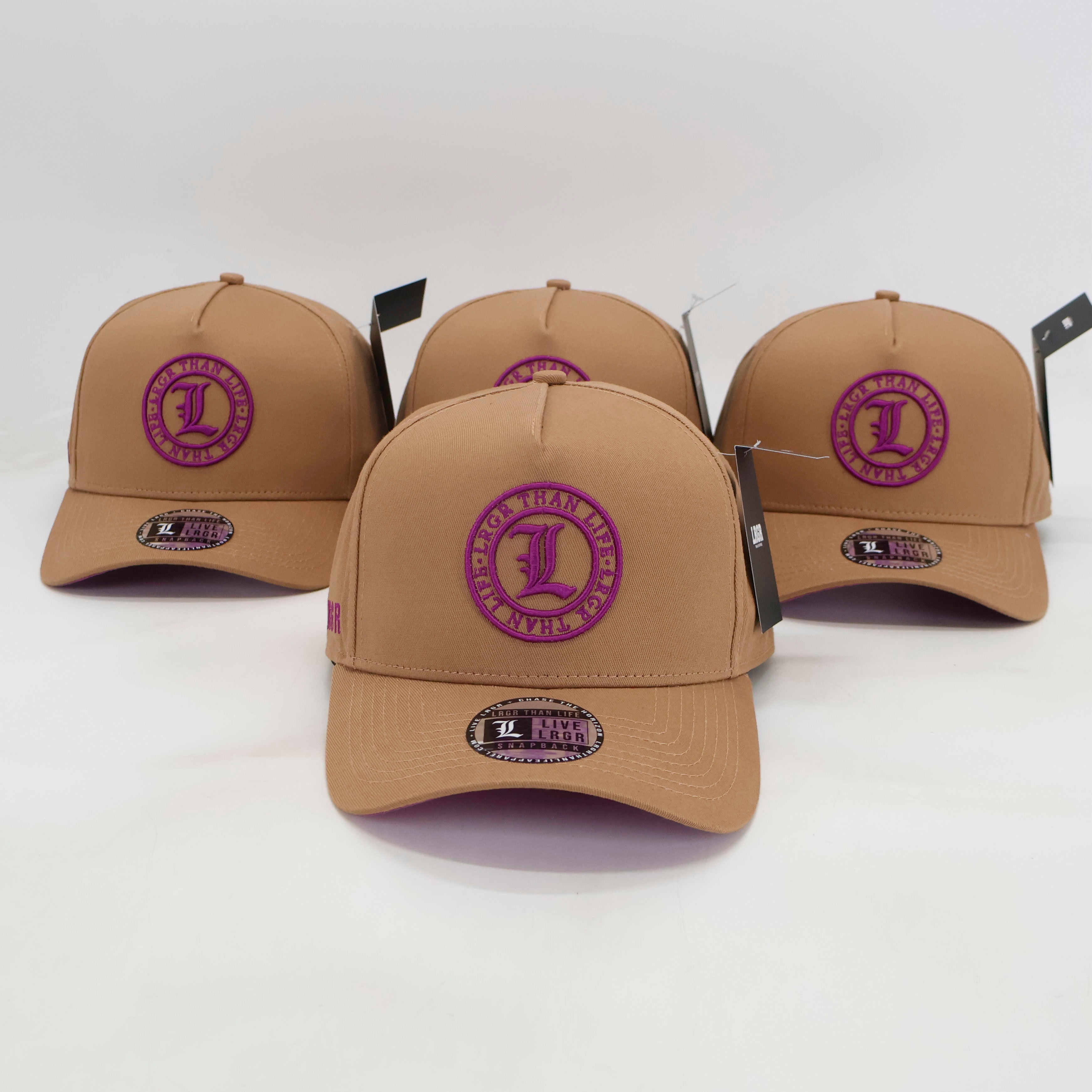 Four tan baseball caps with purple logos on a white background