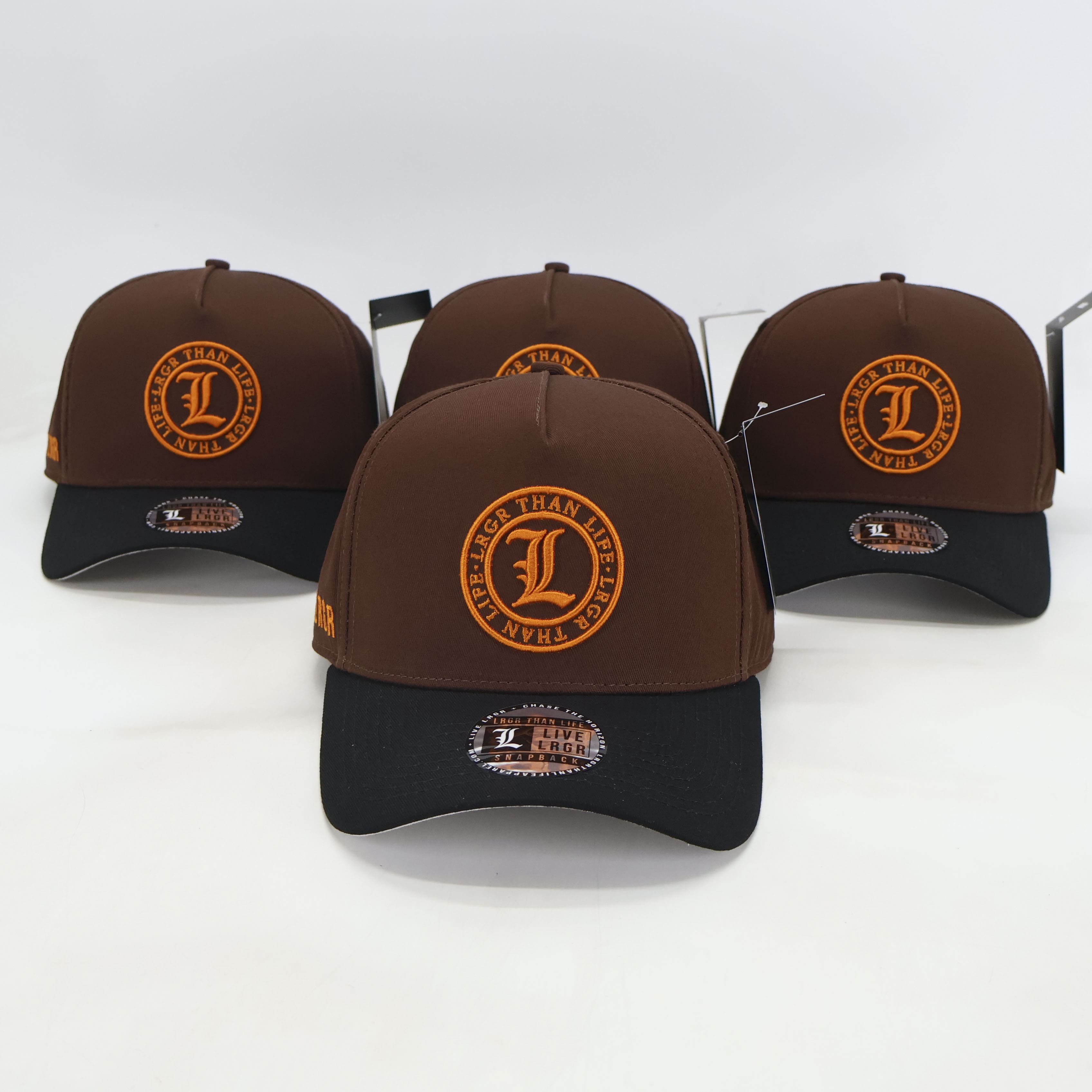 Four brown and black baseball caps with a logo on a white background