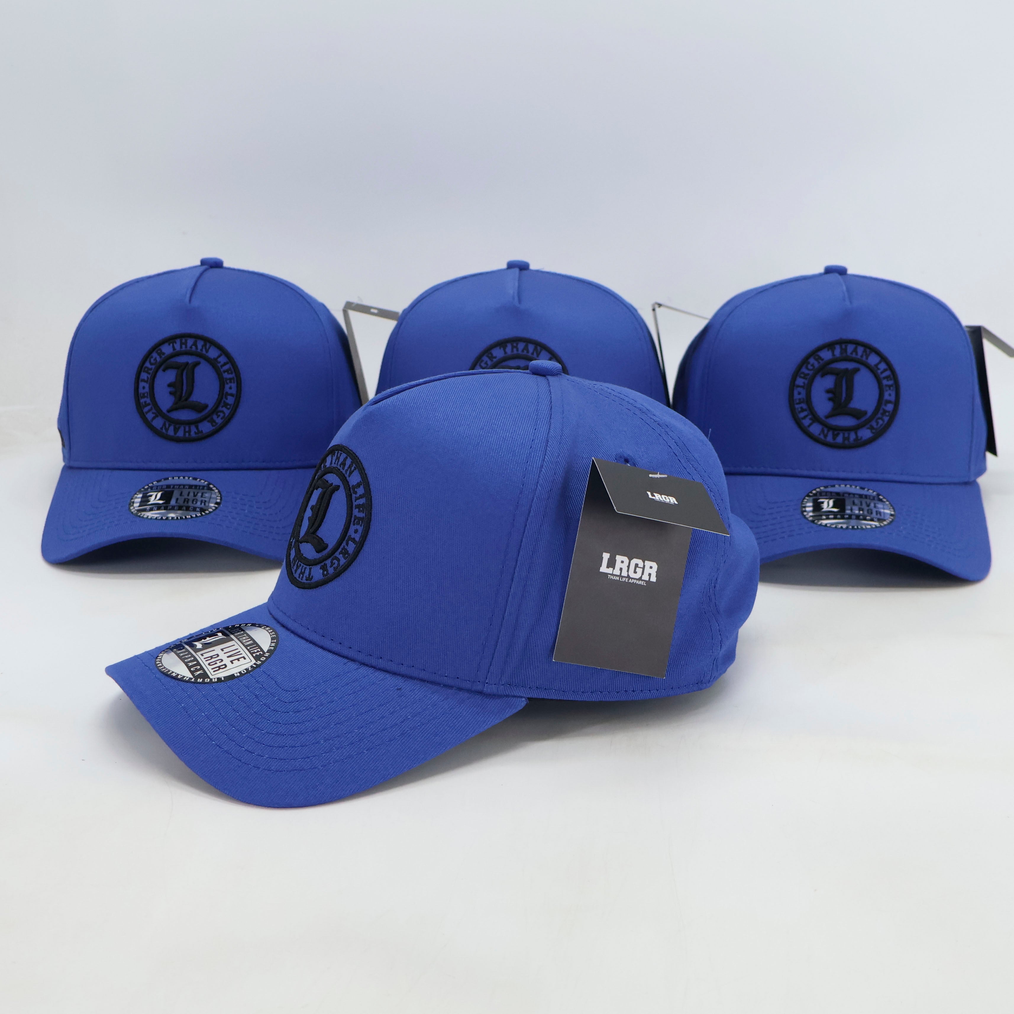 Four blue baseball caps with a brand logo on a white background