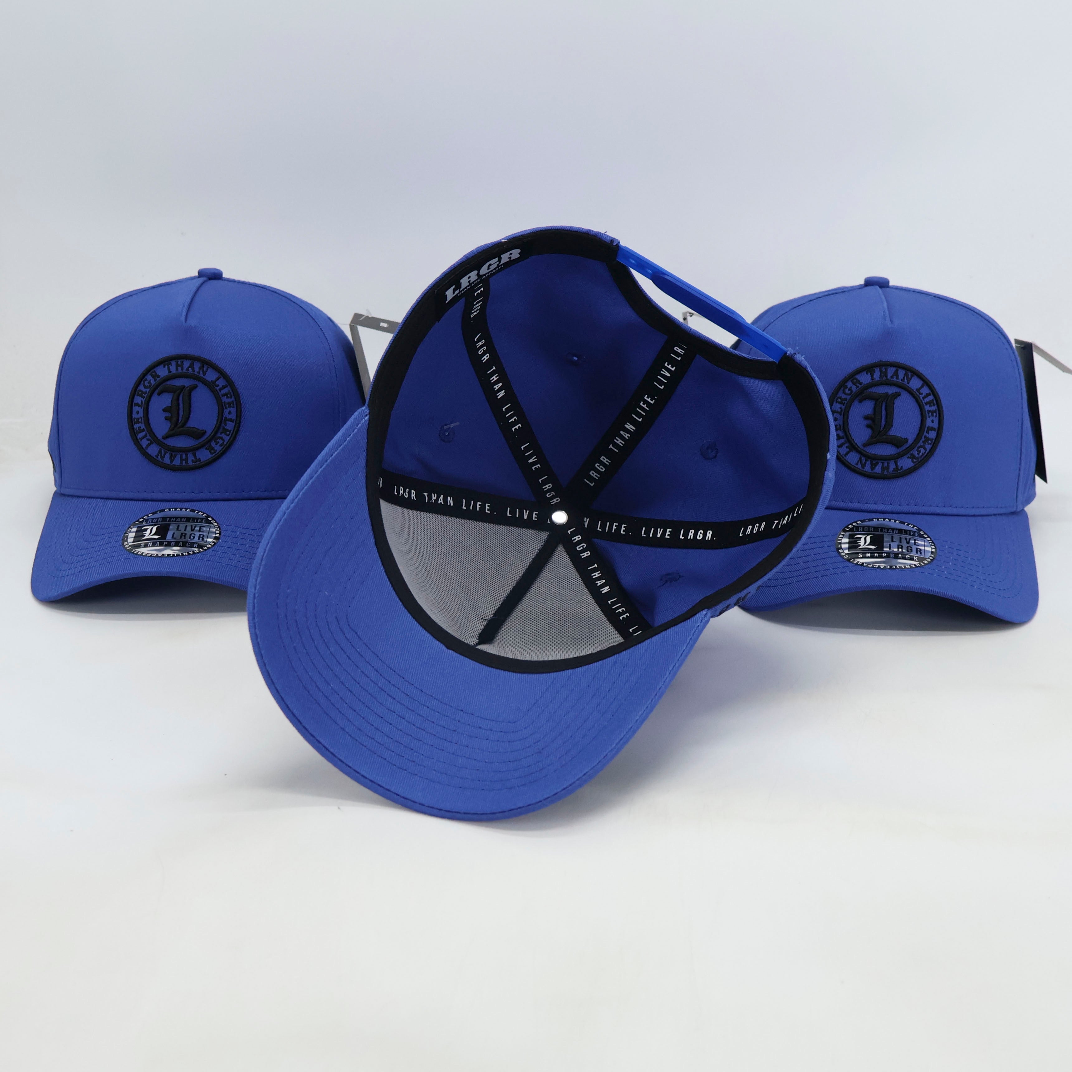 Three blue caps with black logos on a white background
