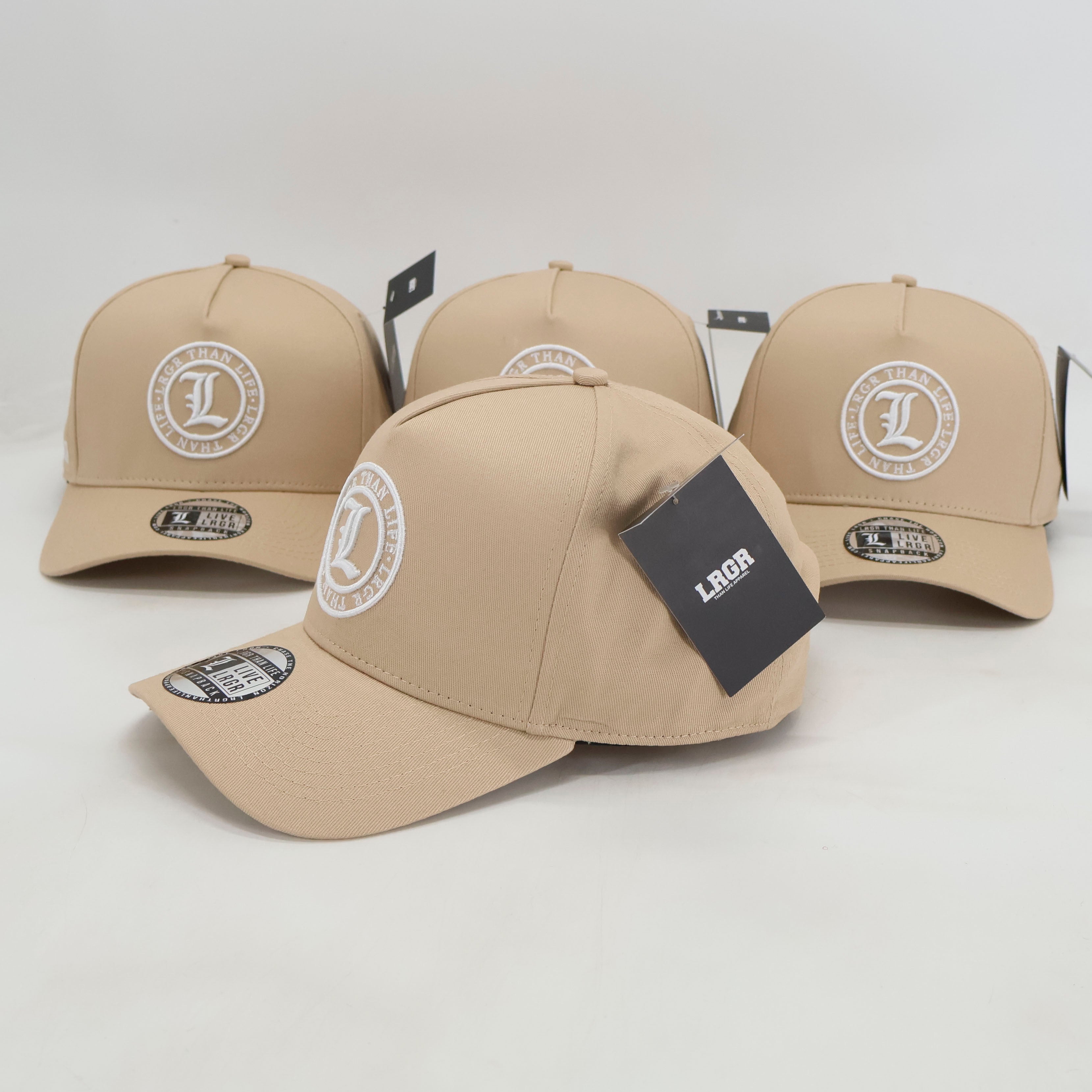 Beige baseball caps with branding on a white background