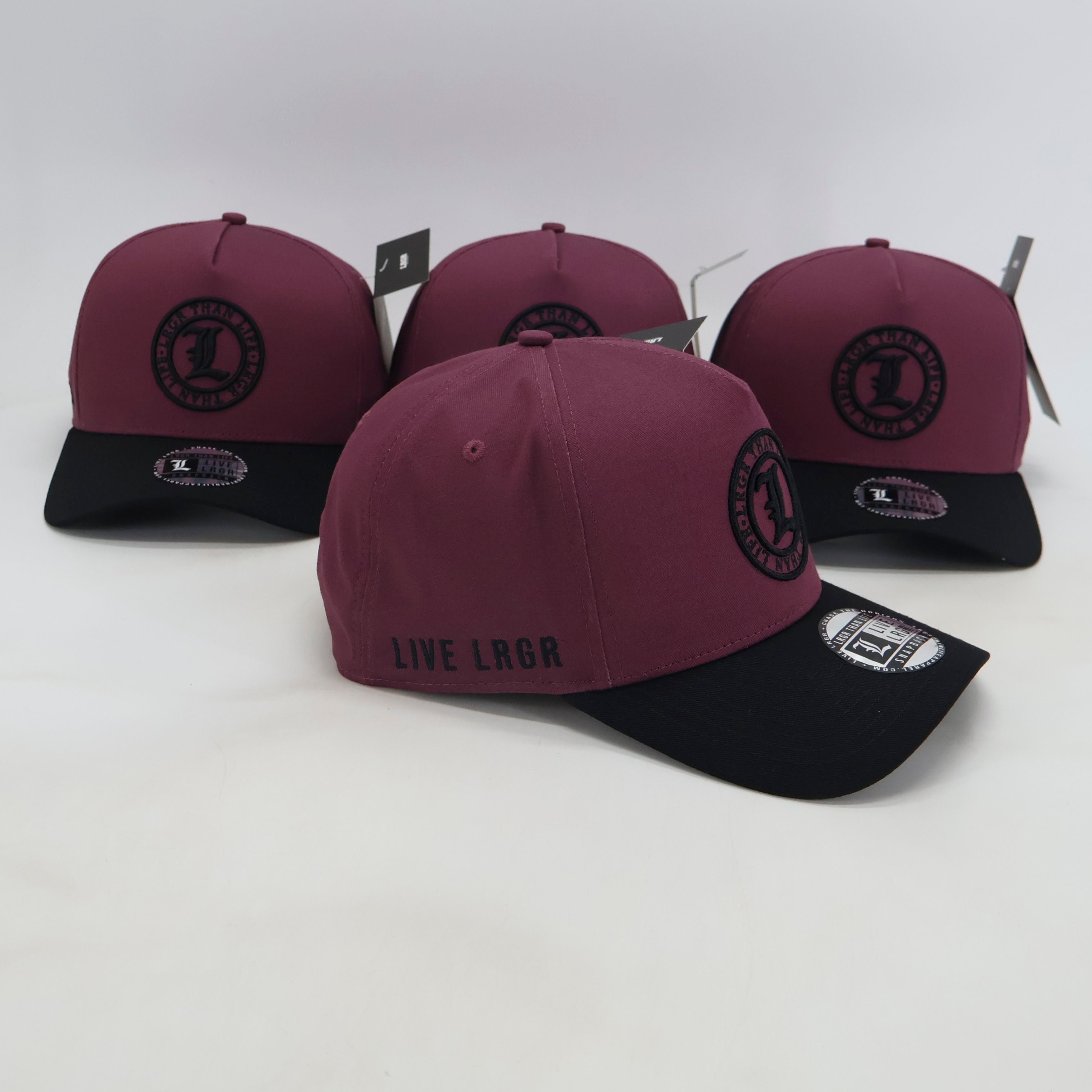 Maroon and black caps with branding on a white background