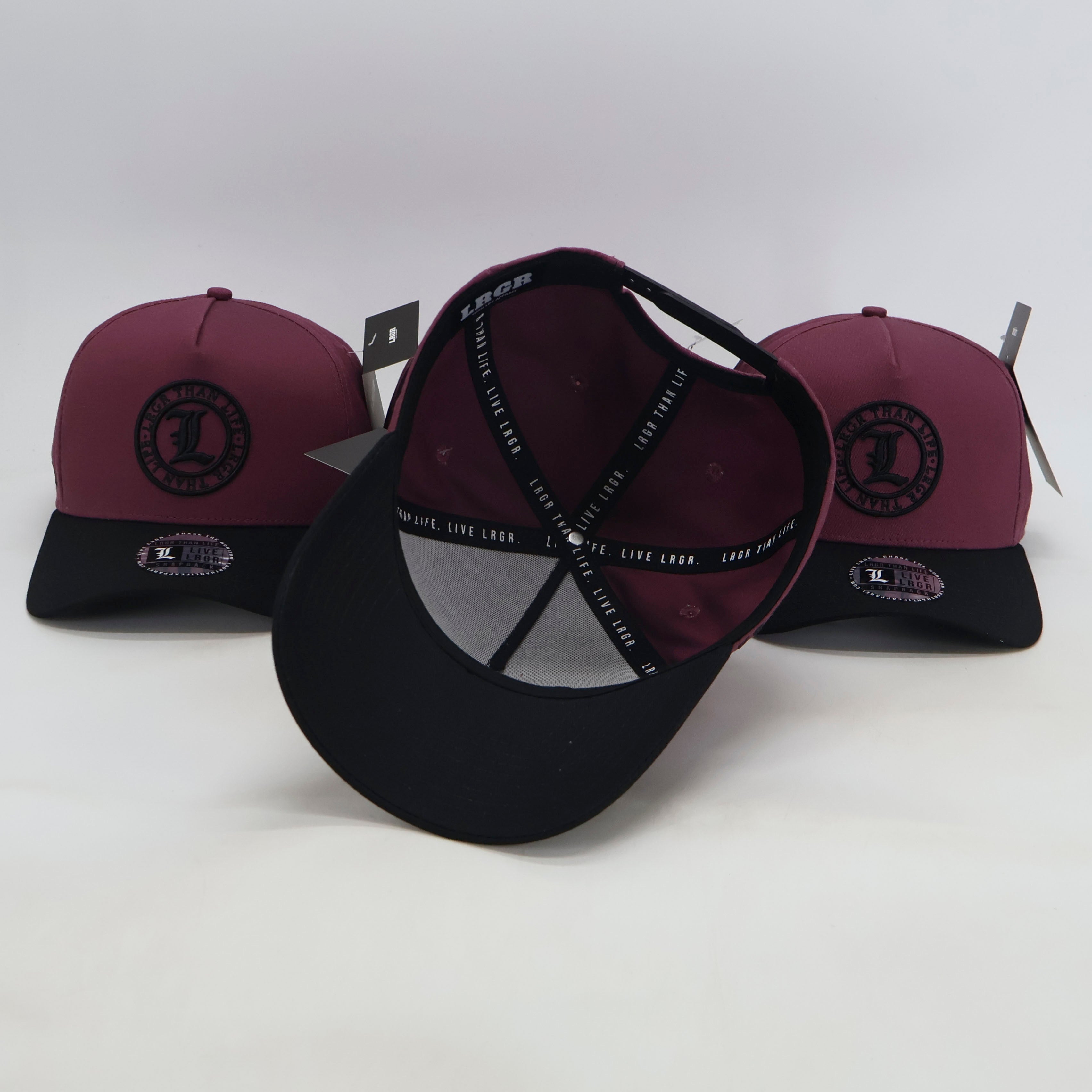 Three maroon and black caps with a logo on a white background