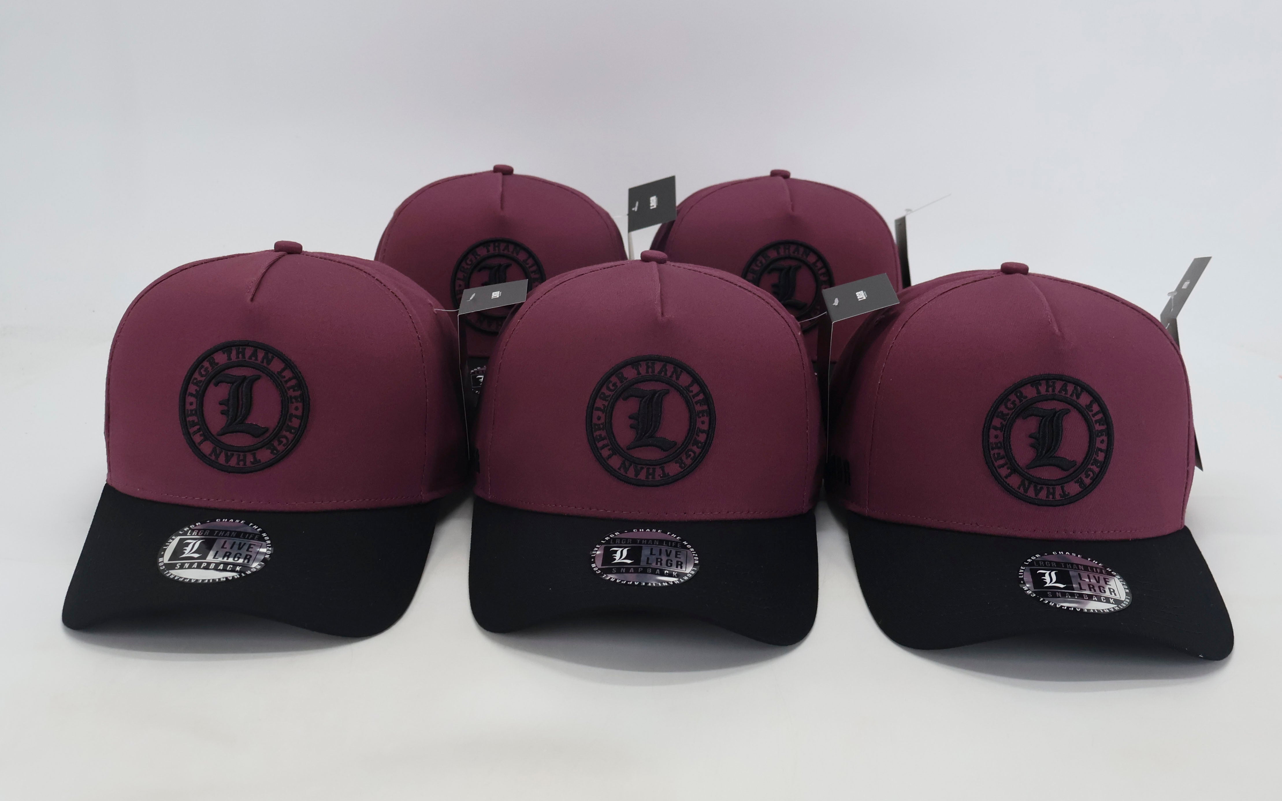 Four maroon and black caps with a logo on a white background